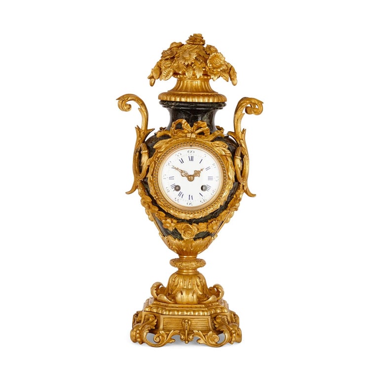 Rococo style gilt bronze and marble mantel clock
French, c. 1870
Height 44cm, width 20cm, depth 15cm

This Rococo style gilt bronze and olive-green mantel clock is designed about the scheme of a green marble vase mounted with gilt bronze features.