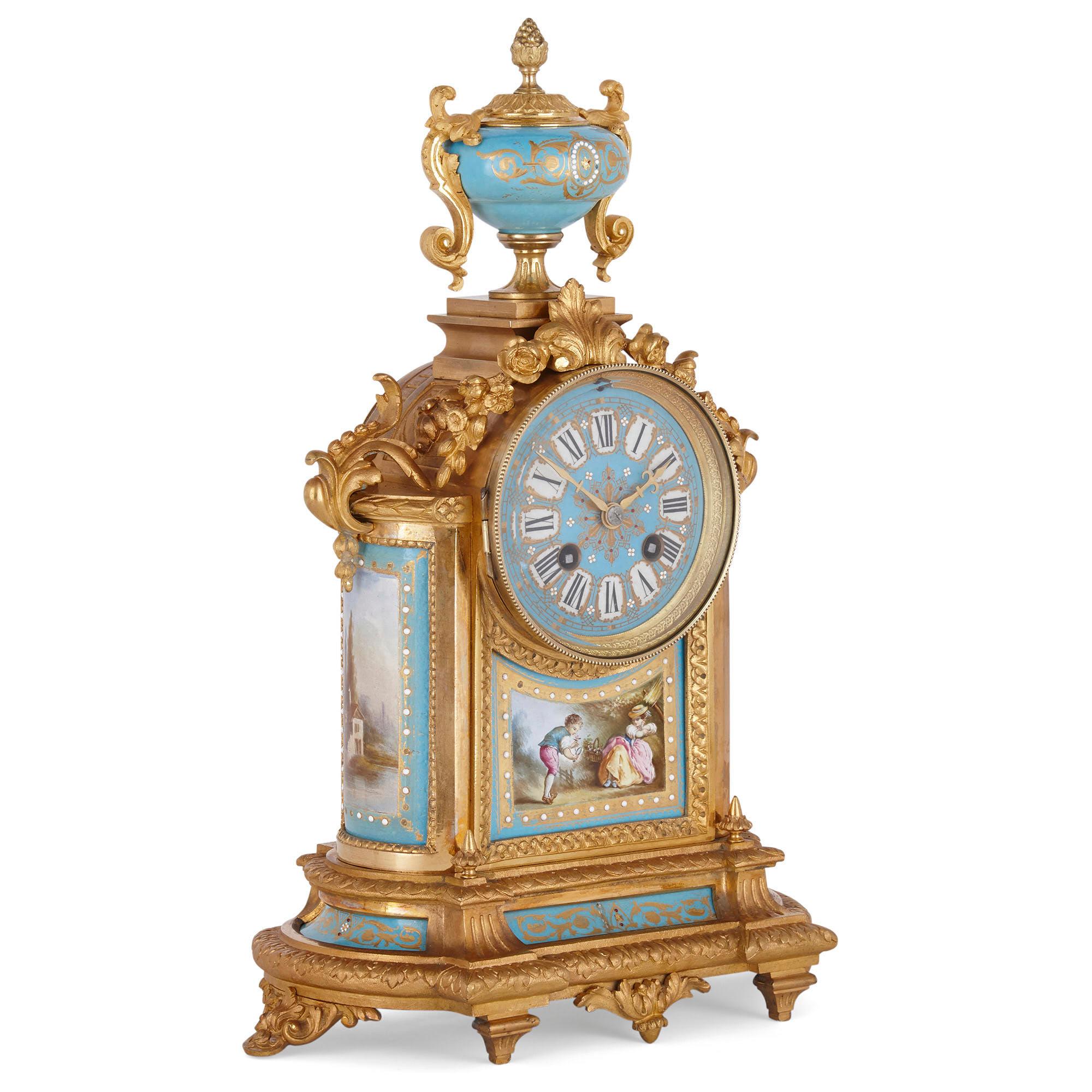 Rococo style gilt bronze mounted porcelain clock garniture
French, late 19th century
Measures: Clock: Height 38cm, width 27cm, depth 13cm
Ewers: Height 32cm, width 14cm, depth 9cm

This beautiful clock set includes a mantel clock and a charming