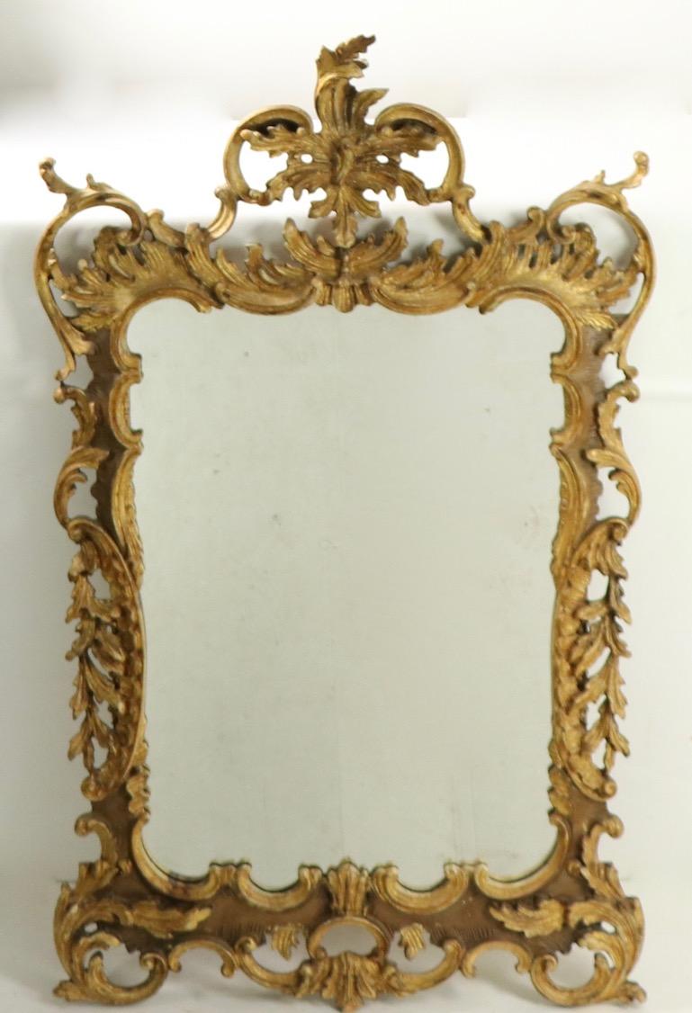 Ornate carved wood mirror in the Rococo style by Labarge. Very good, original and ready to hang.