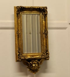 Rococo Style Gilt Wall Mirror with Putti and Shelf Bracket