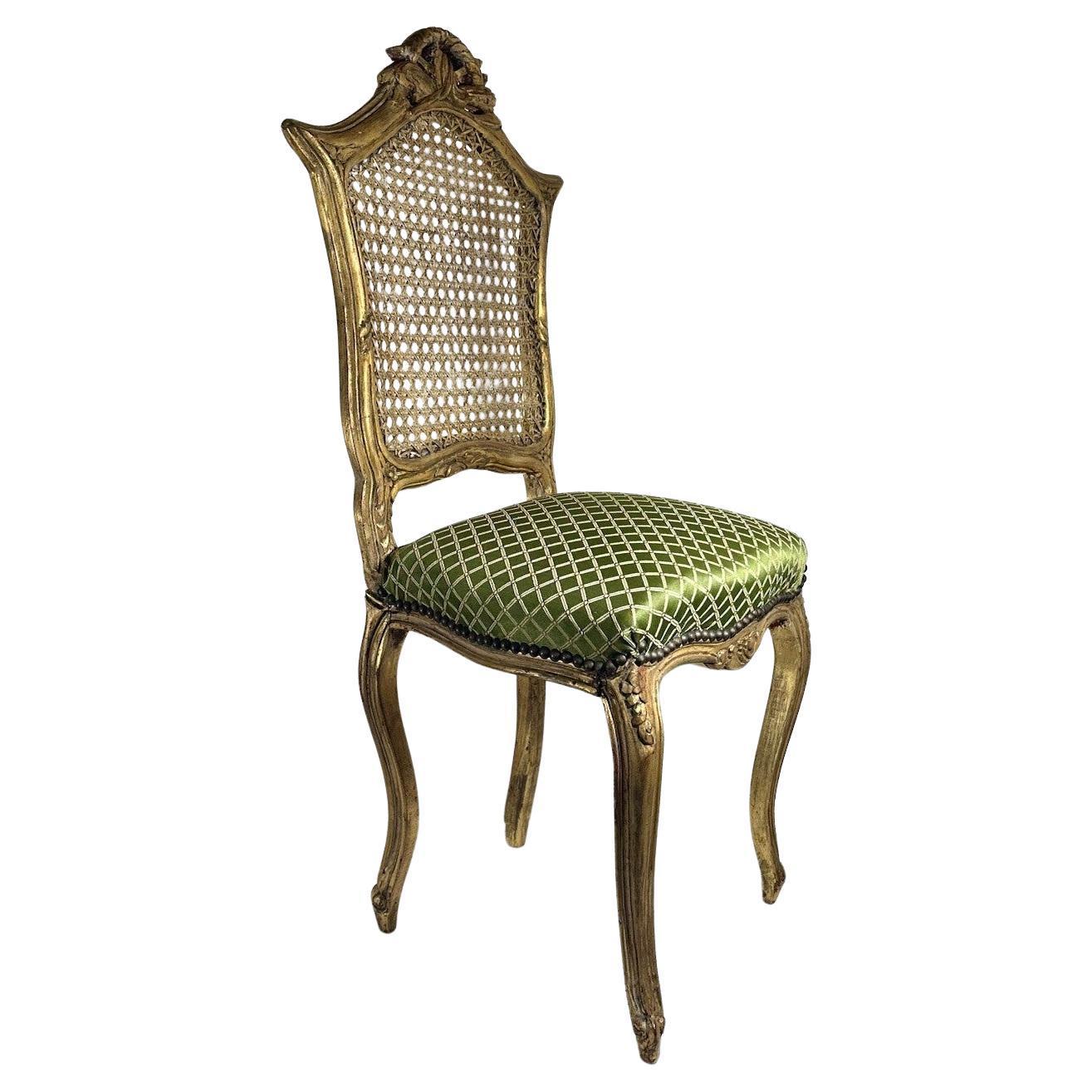Rococo Style Giltwood Cane Chair with Upholstered Seat, Side Chair.

This petite chair raised on cabriole legs features a caned backrest that is complimented by an upholstered seat in green with gold lattice pattern. Condition is very good.  Wear