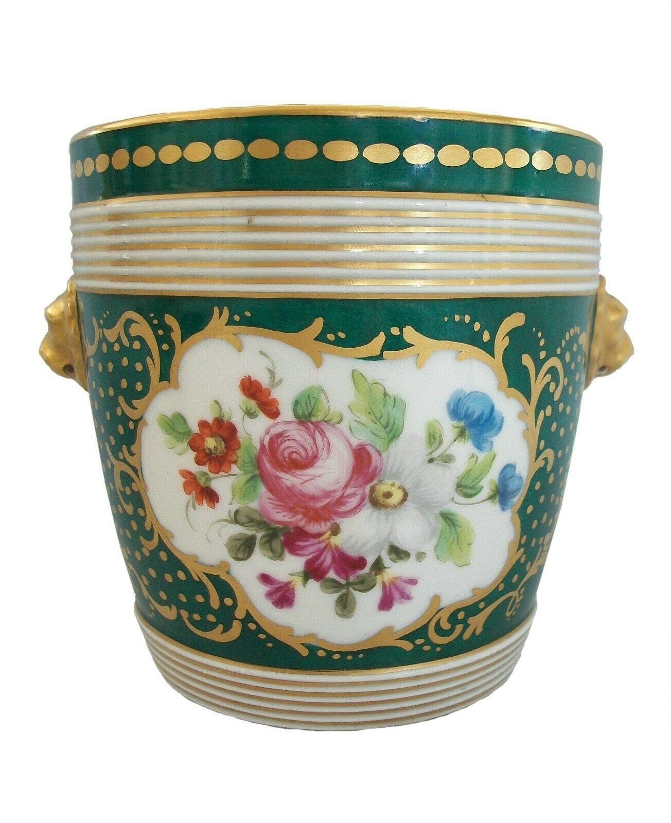 Vintage Rococo style hand painted and gilded ceramic cachepot - featuring floral panels to the front and back - gold gilt scrolls, flowers and butterflies with lion's head mask handles in relief to the sides on a forest green ground - gilt rim -