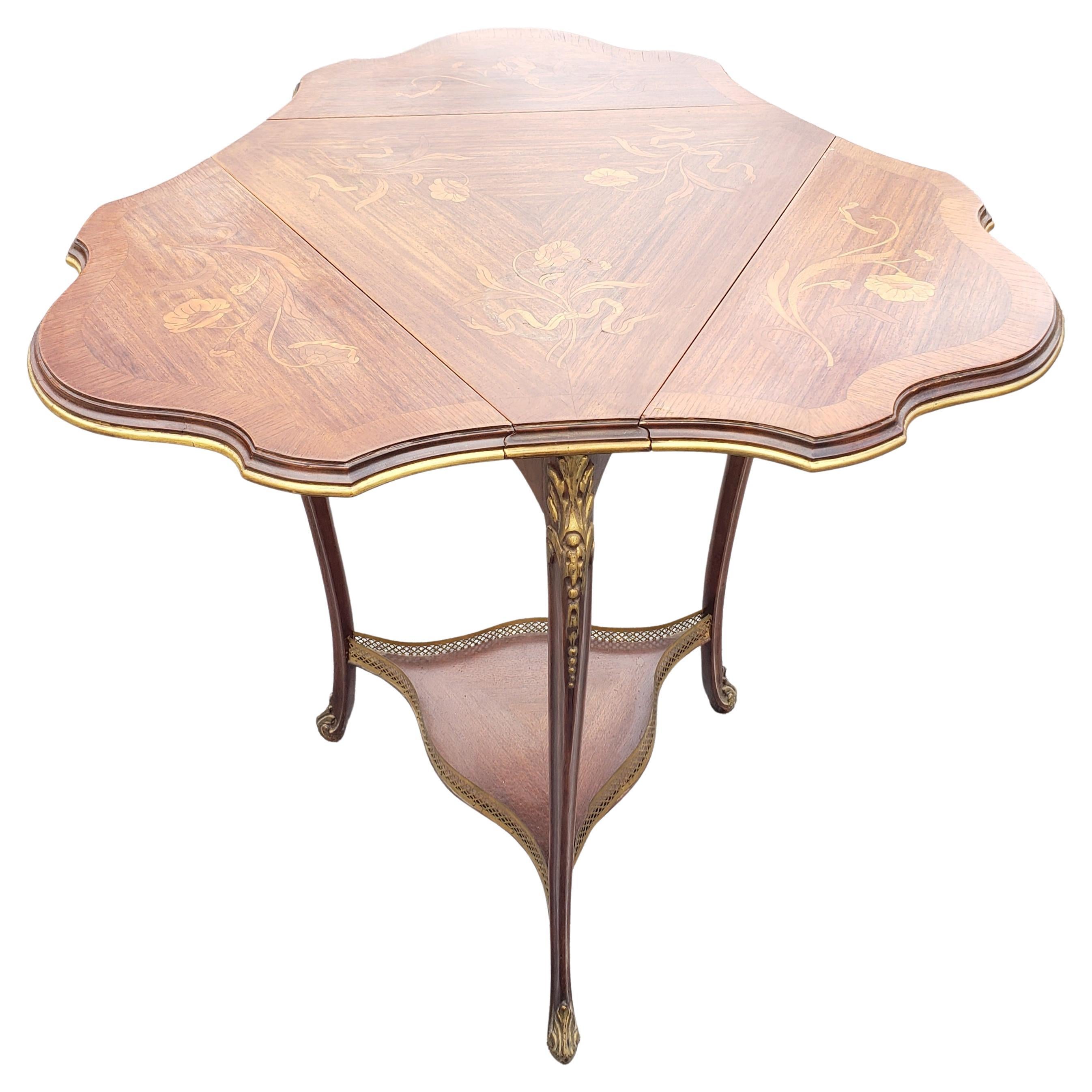 A French Rococo style marquetry fruitwood & gilt metal mounted triangular drop leaf table. 
Measures 21