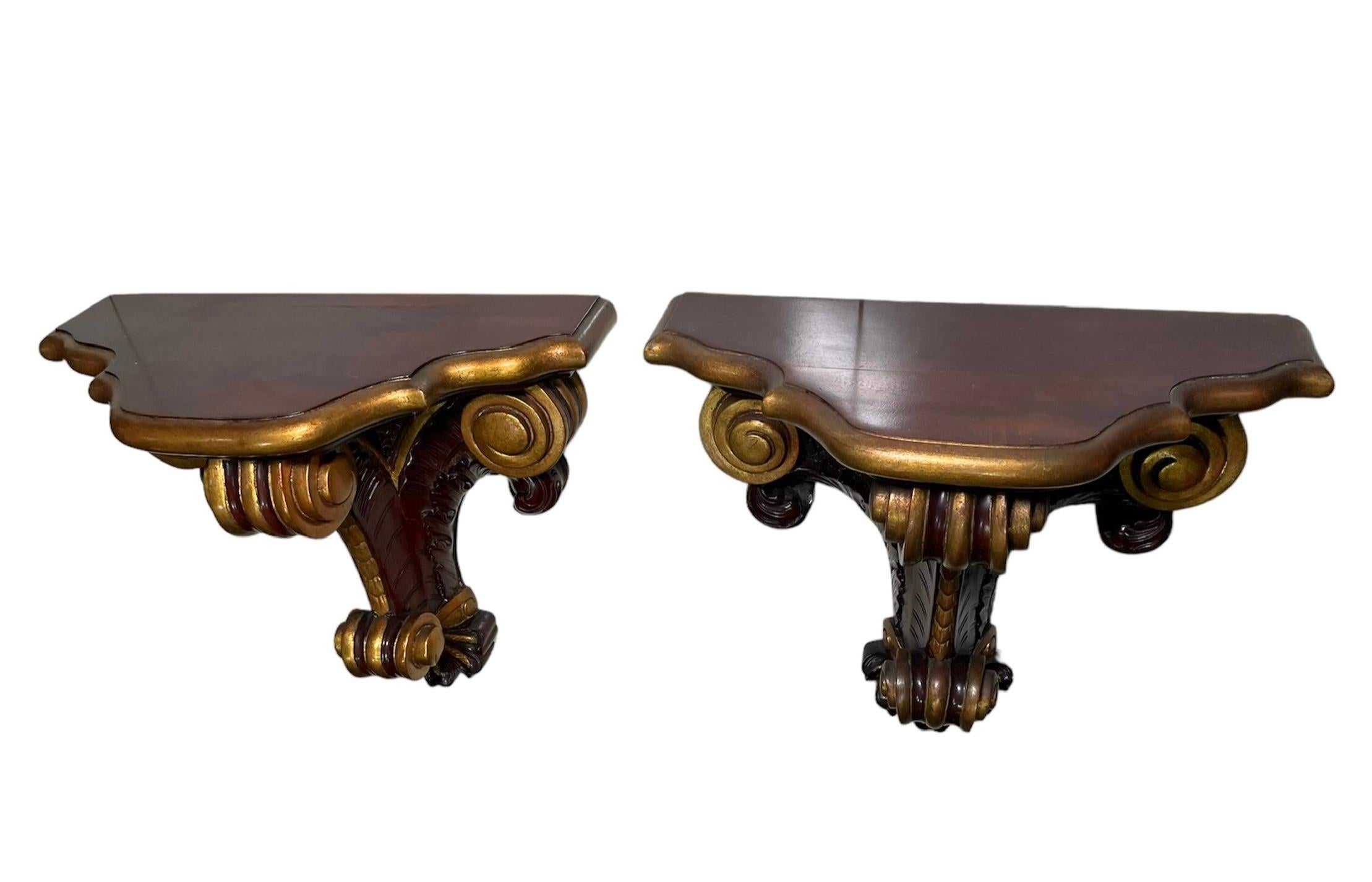 This is a Rococo Style Pair of heavy Wood Bracket/Shelves. It depicts a pair of gilt dark brown wood brackets/shelves with kind of demilune top with serpentine borders. The tops are supported by three wide scrolls. The scrolls of the sides are