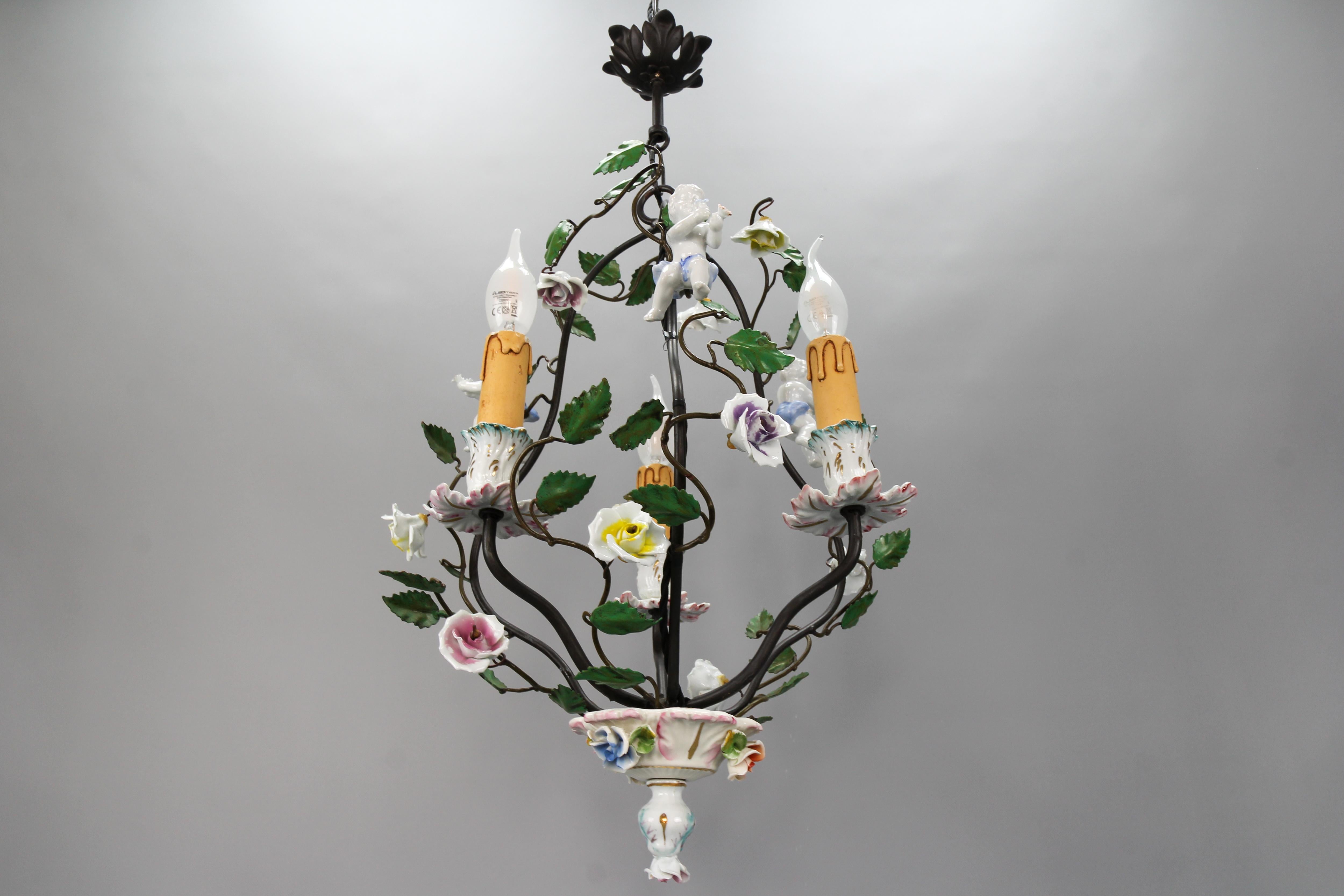 Rococo Style Porcelain Cherub and Metal Three-Light Chandelier, Germany, circa the 1970s.
Beautiful Rococo-style metal chandelier, adorned with porcelain flowers and three porcelain cherubs.
Three sockets for E-14 size light bulbs.
Dimensions:
