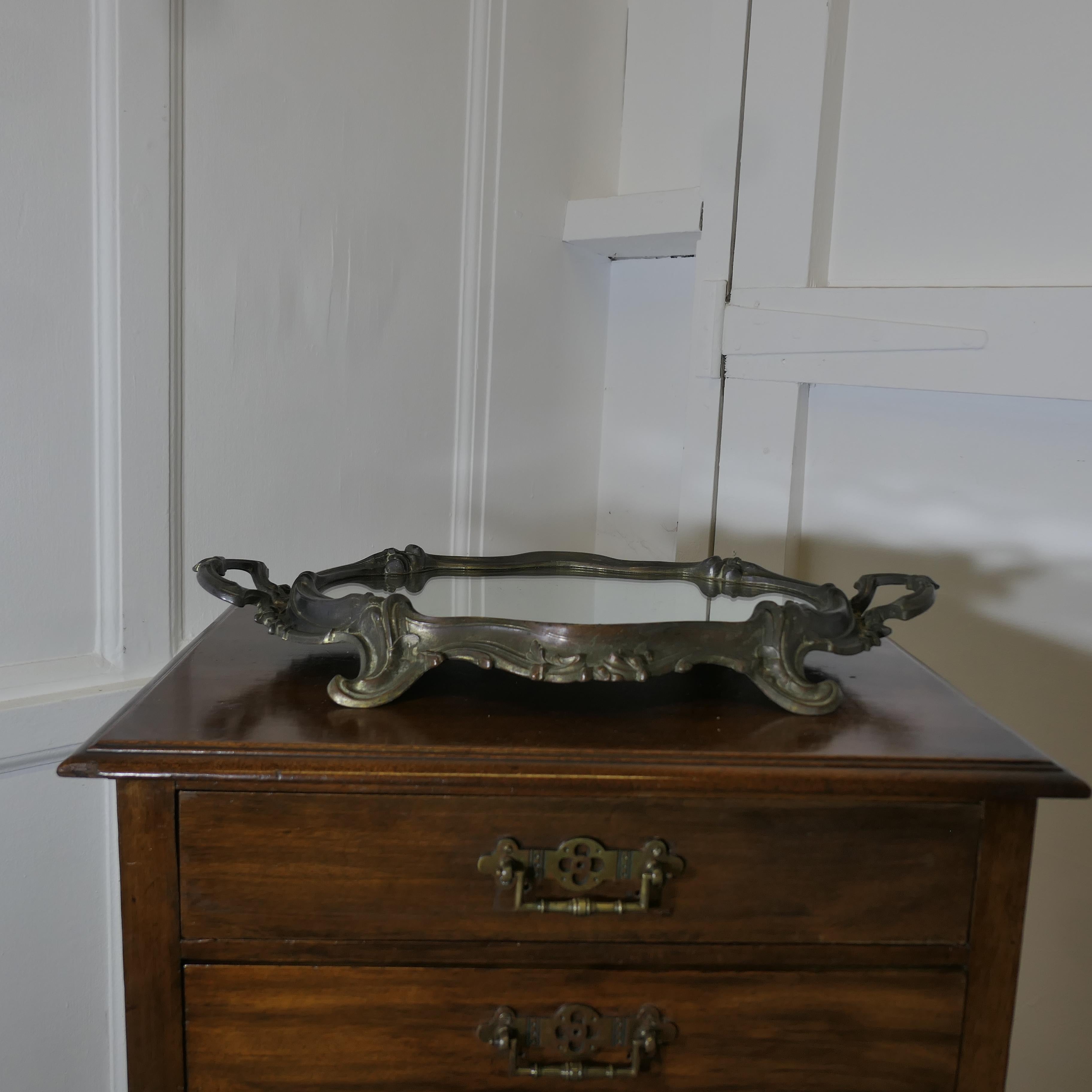 Plateau à miroir, plateau à vin, buffet de style Rococo en métal argenté

Il s'agit d'une pièce charmante, le plateau a une forme ovale irrégulière avec des pieds et des poignées, il est lourd pour sa taille, la base du plateau est en miroir.
Une
