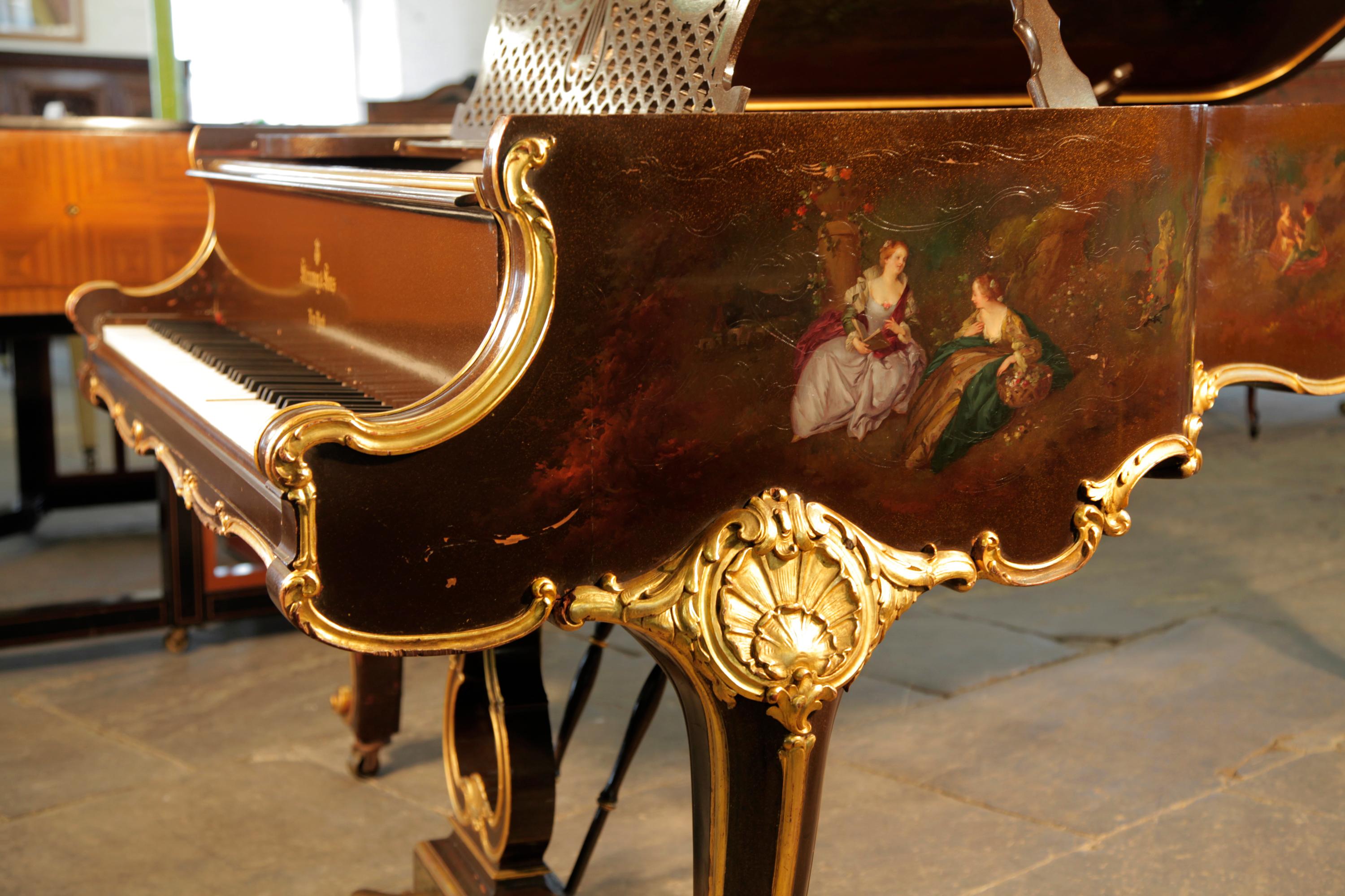 Rococo Style, 1904, Steinway Model B grand piano.
Music desk is in a cut-out latticework design with a central lyre motif decorated with draping swags.
The three-pedal piano lyre with brass footplate is in a scrolling S-curve acanthus design with