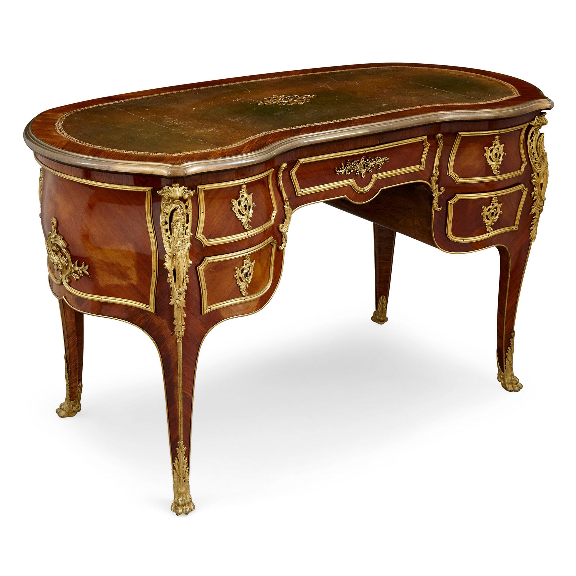 Rococo style writing desk mounted with gilt bronze
French, late 19th century
Measures: Height 78cm, width 134cm, depth 64cm

This superb Rococo style desk was produced in the late nineteenth century in the style that predominated during the