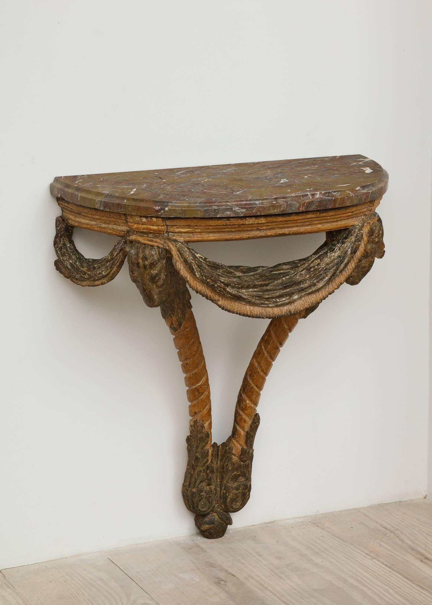 A fine Rococo wall console with exceptionally hand-carved swags, acanthus leaves and rams heads with its original Swedish stone top and original color with a gorgeous patina, circa 1750, origin: Stockholm, Sweden.

 