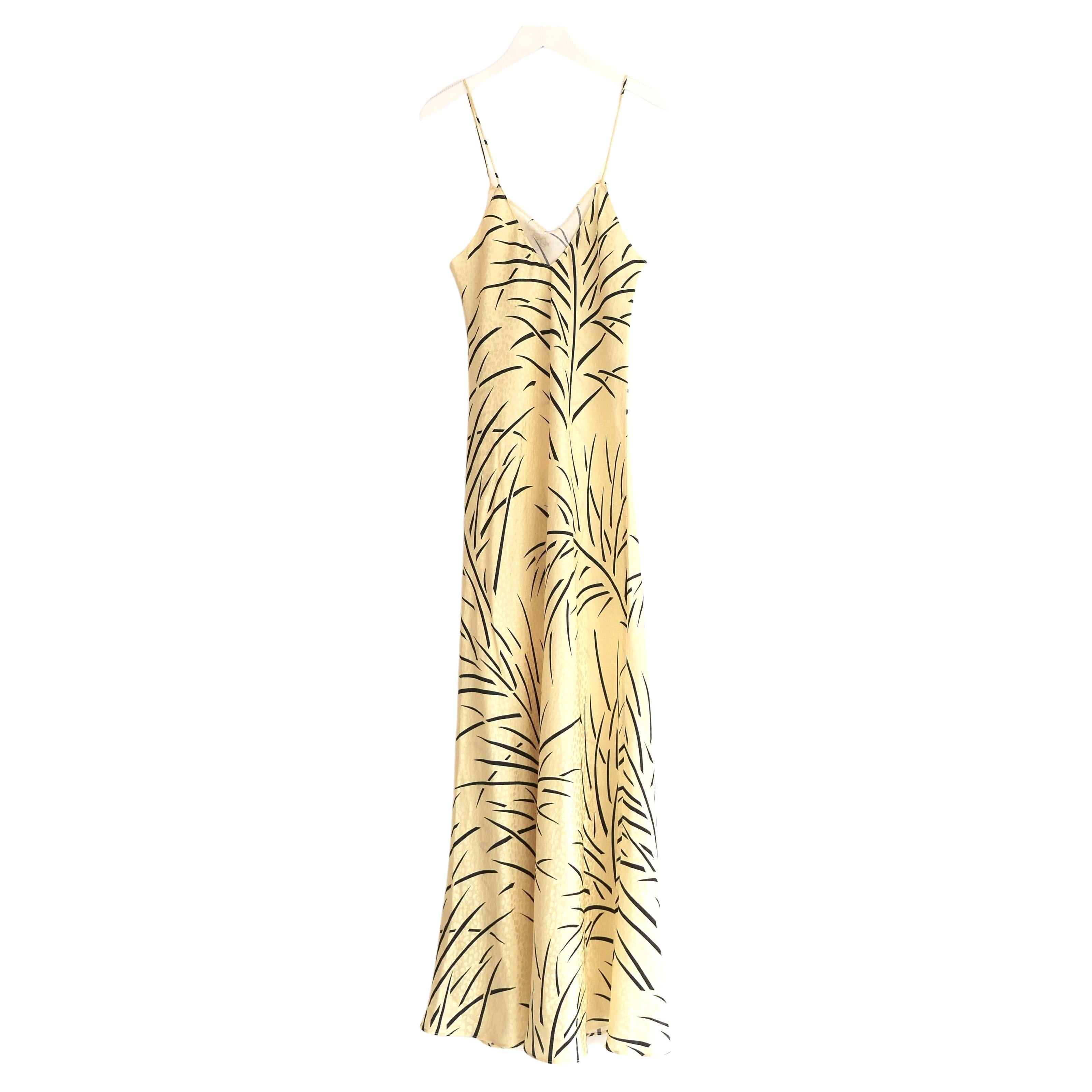 Slinky Rodarte corsage embellished slip dress. Bought for £825 and unworn. Made from sherbert yellow palm print silk, it has a super flattering bias cut, delicate spaghetti straps and removable hand crafted silk organza rose corsage to bust. Size