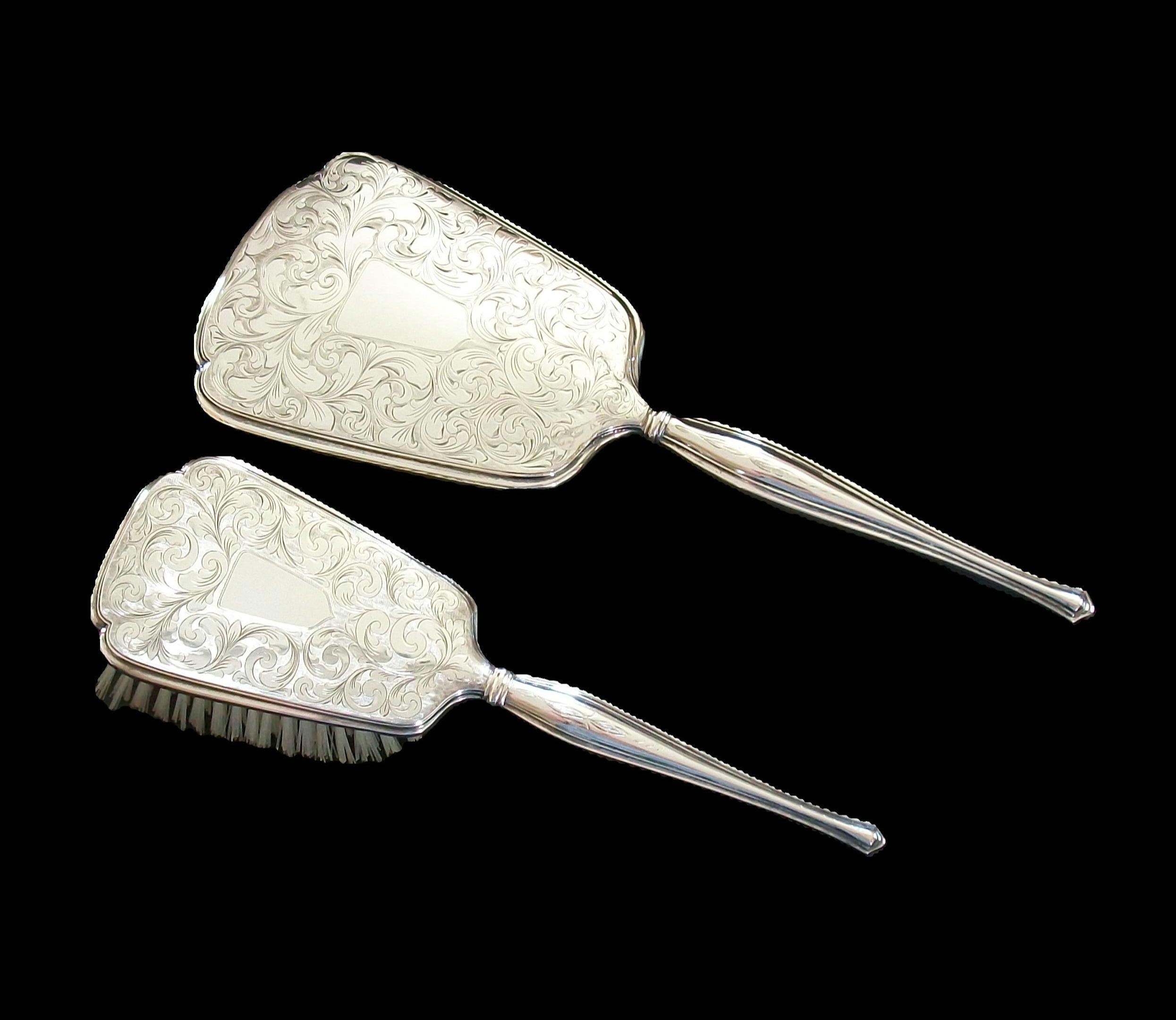 RODEN BROTHERS - Fine quality rare Edwardian antique sterling silver grooming set - heavy weight - featuring engraved and chased over-all scrolling leaf pattern with open shields (not engraved) to both the hand mirror and brush, additional engraved