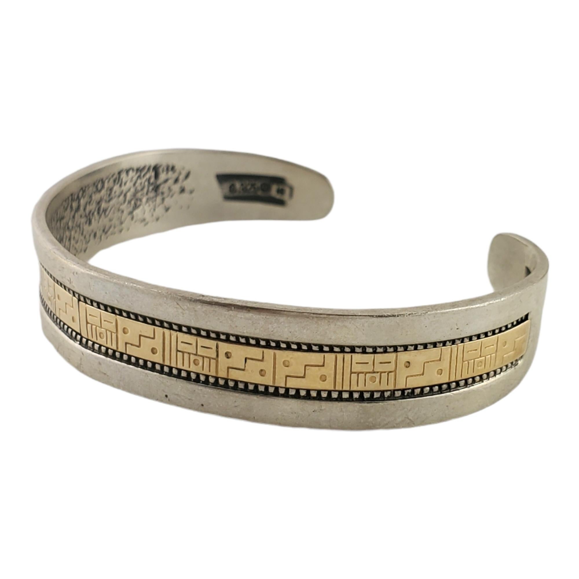 Roderick Tenorio RMT sterling silver and 14K gold cuff bracelet.

Marking: Relios hallmark, .925, ©, 14K, RMT.

Measures approx. 5 1/2