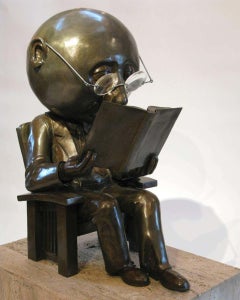The Reader, by Rodger Jacobsen, bronze, large, big head, book, glasses, chair