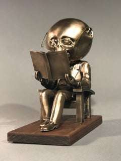 The Reader (small), gold bronze sculpture, reading book, glasses, Rodger Jacobsen