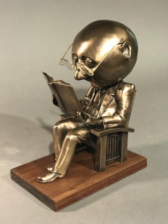 The Reader (small), Rodger Jacobsen gold bronze sculpture, reading book, glasses 