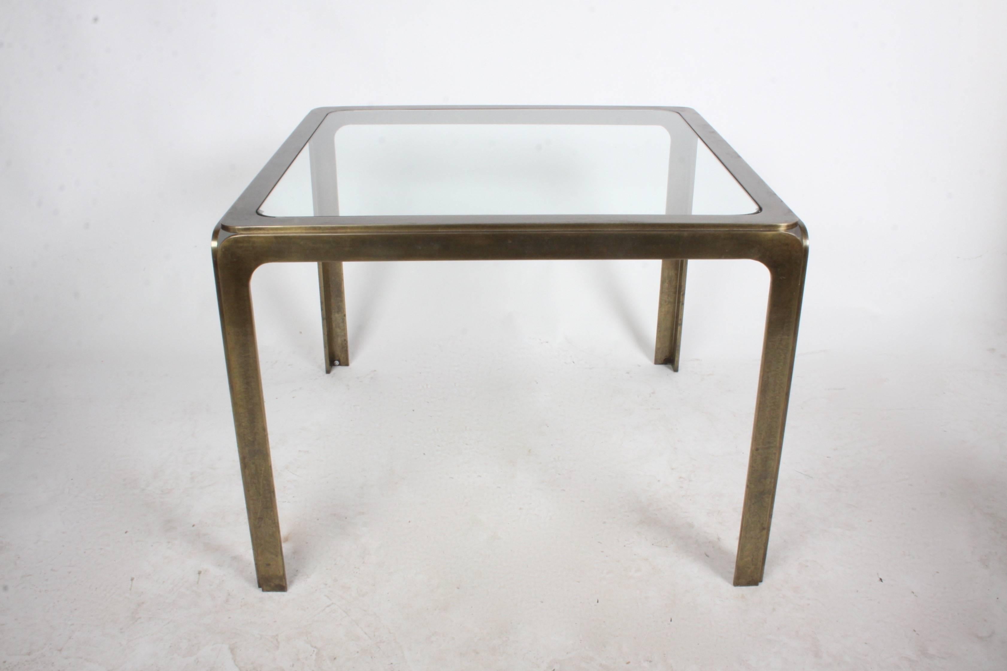 End table or occasional table in solid bronze, in the style of Mastercraft. The unique radius bronze frame forms open corners. Table also reminds me of Rodger Sprunger for Dunbar. Glass has surface scratches. Well constructed, great patina.