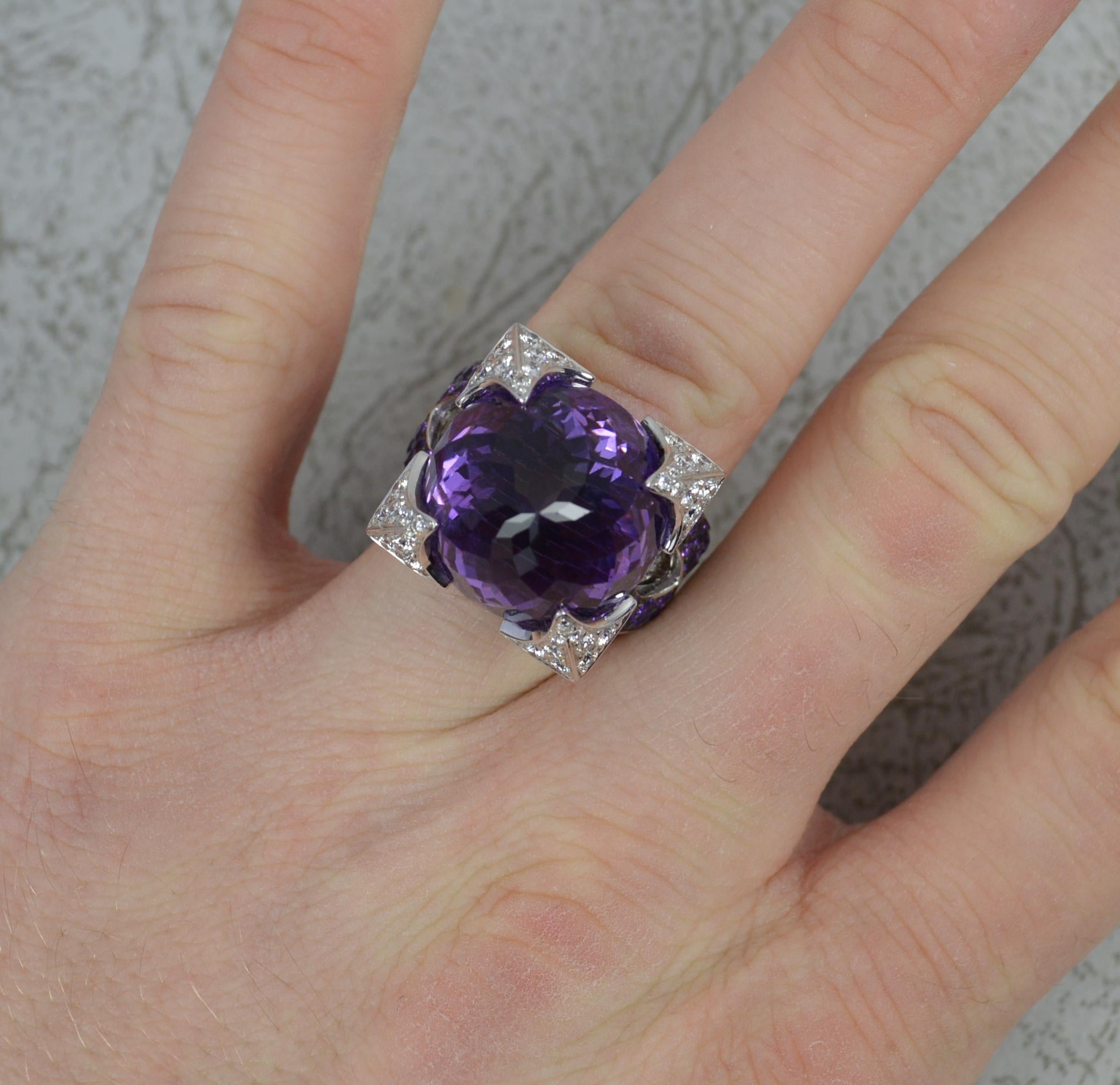 A striking Rodney Rayner designer ring. Part of the Dragon range.
Solid and heavy 18 carat white gold example.
Facet cut top amethyst to centre, 16mm diameter. Four large claws to each corner, pave set with round brilliant cut diamonds.
To the