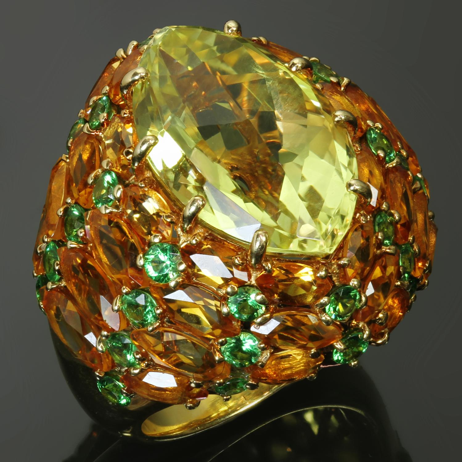 This stunning Rodney Rayner ring is crated in 18k yellow gold and set with a faceted marquise-cut citrine, yellow sapphires, and tsavorite garnets - all vibrant fine quality stones. The citrine measures 11.5mm x 18.0mm. Signed Rayner RHR, stamped