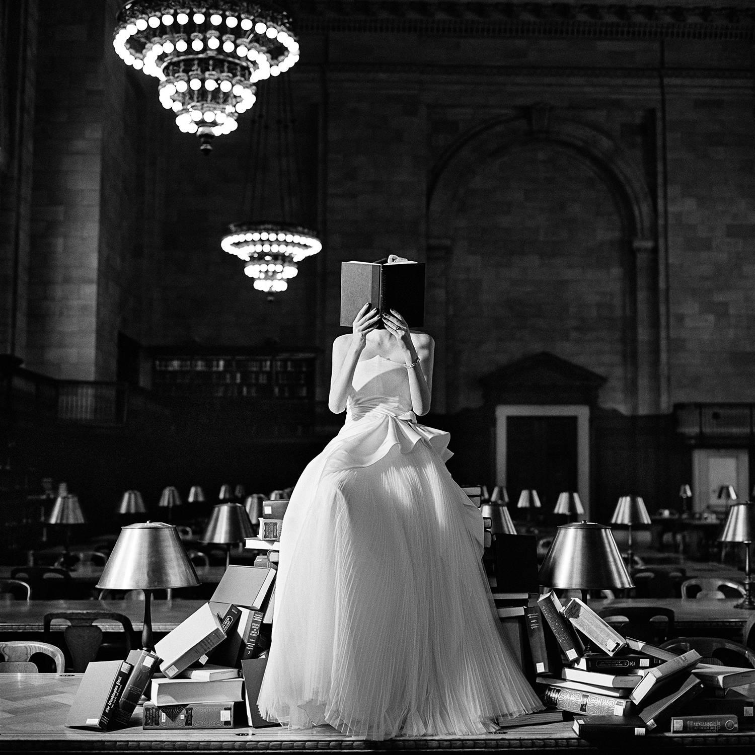 Rodney Smith Figurative Photograph - Flynn Reading on a Pile of Books, New York, NY- black and white fashion photo