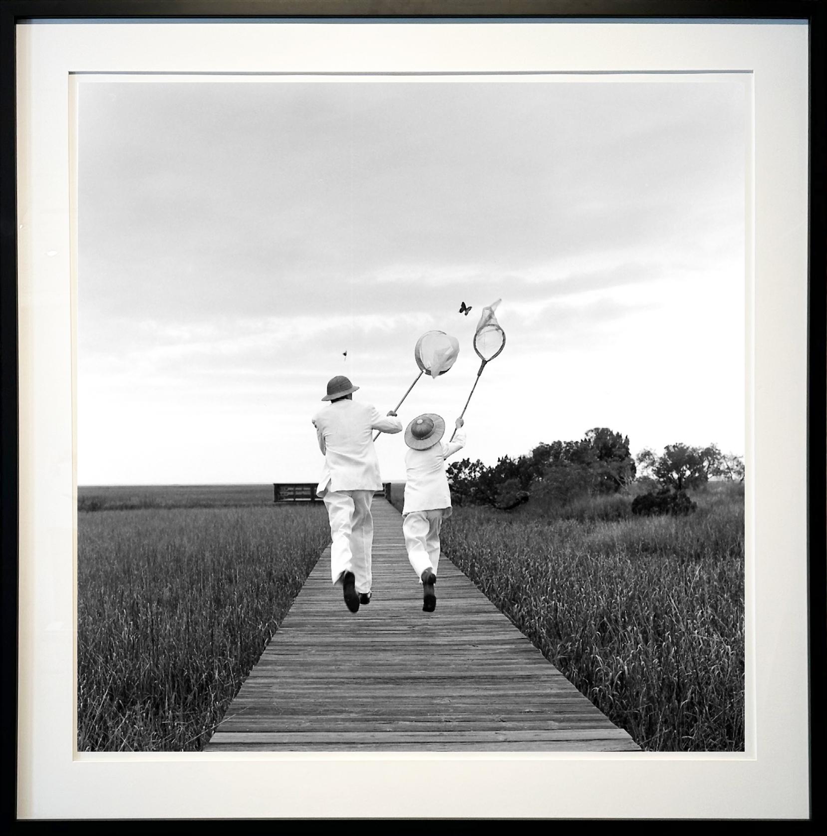 Rodney Smith Black and White Photograph - Gary and Henry chasing butterfly, Beaufort, SC - 50 x 50 inches, Framed