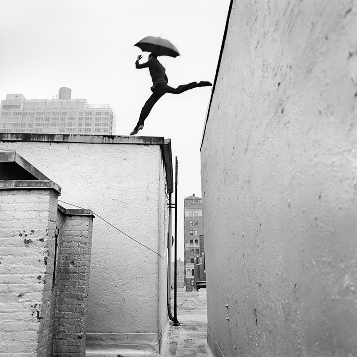 Rodney Smith Black and White Photograph - Reed Leaping Over Rooftop, New York