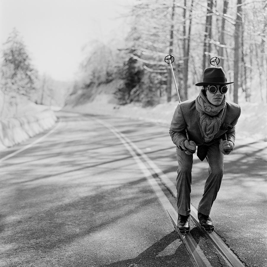 Rodney Smith Figurative Photograph - Reed Skiing in Road, unframed 40 x 40 inch black and white skiing print