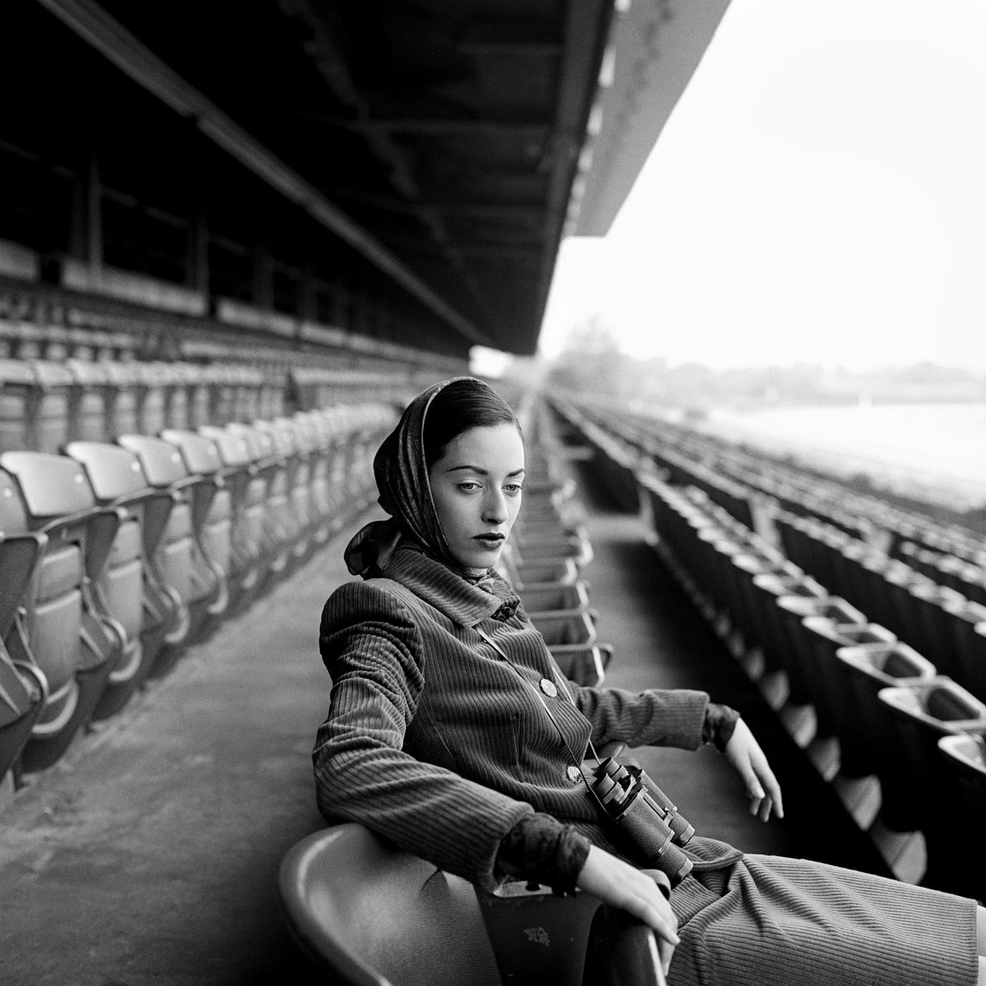 Rodney Smith Figurative Photograph - Shirley seated in grandstand, Long Island, New York - 20 x 20 inches