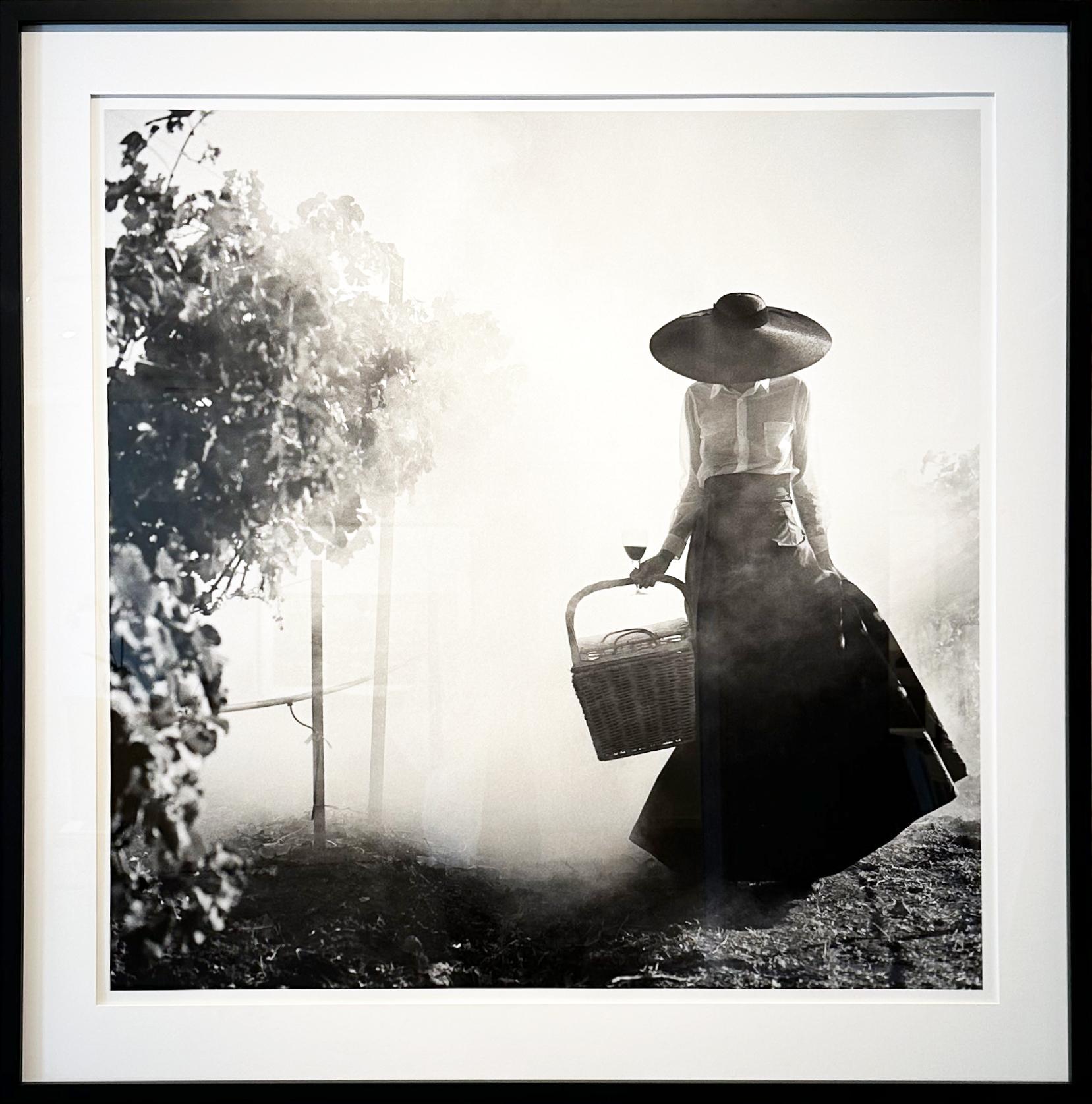 Rodney Smith Figurative Photograph - Woman Holding Up Dress Walking Through Vineyard, Napa Valley - FRAMED