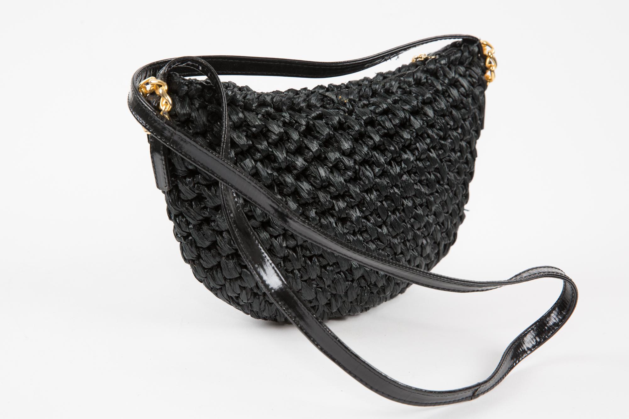 Rodo black raffia shoulder bag featuring a woven raffia pattern, a  long shape, a shoulder tarnish leather handle (length: 43in (109cm))  gold- tone hardware, a top zipped logo fastening, and inside plaque and an inside pocket.
Circa: 1980s
In good