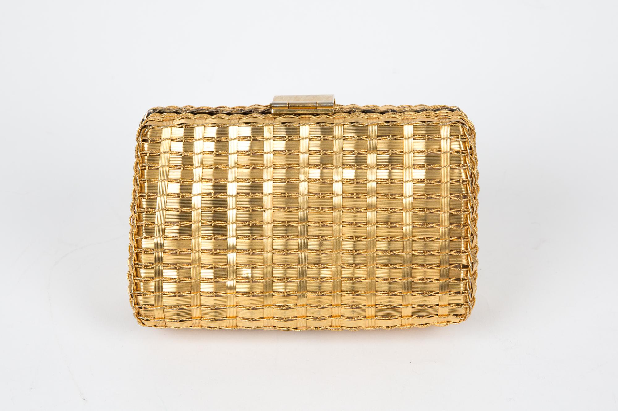 Rodo gold-tone metal clutch bag featuring gold-tone metal woven, a claps opening, a rectangular shape, a leather gold-tone lining, and inside red stamped signature and an inside pocket.
Circa: 1970s
In good vintage condition. Made in Italy.
Length: