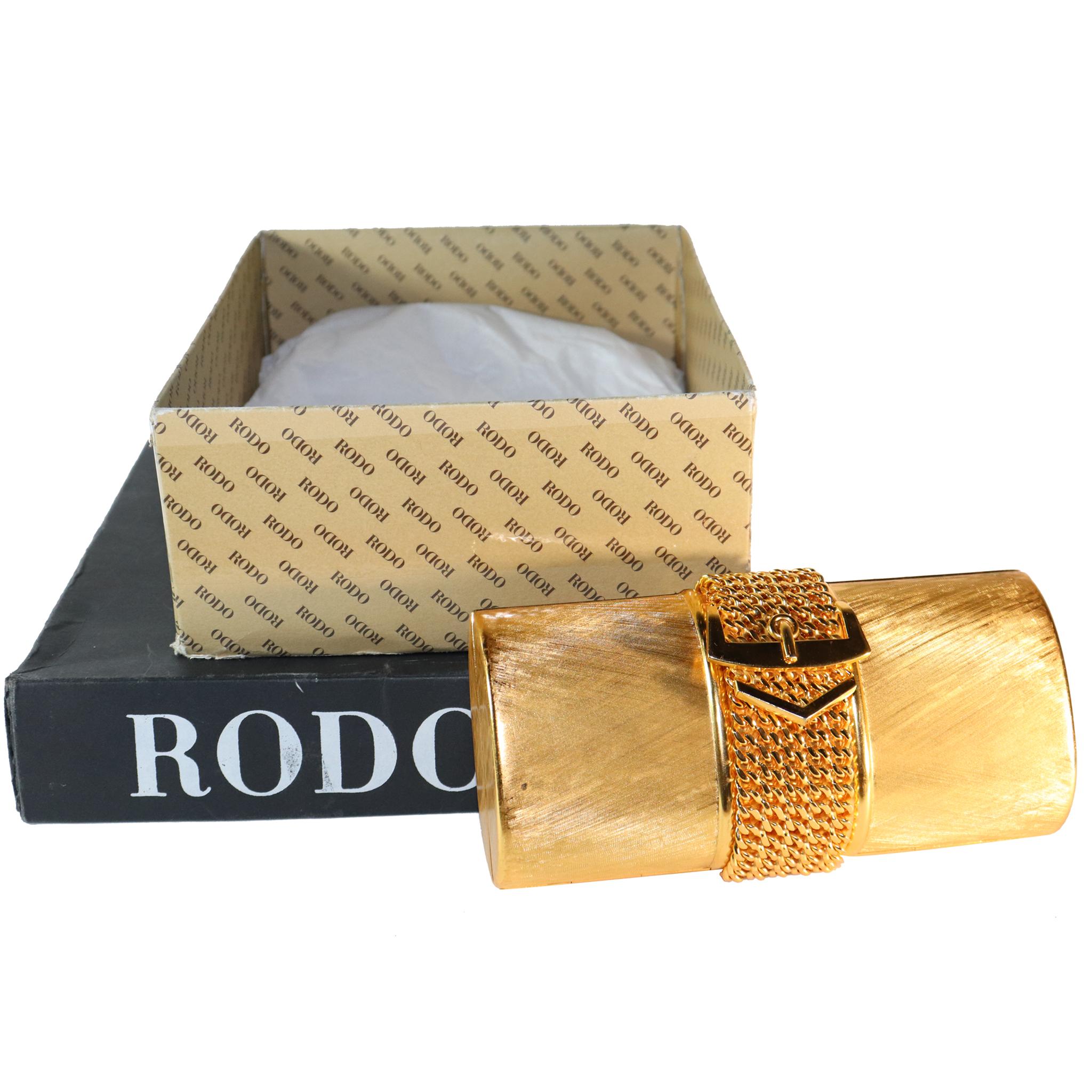 Rodo Golden Minaudière Handbag with Buckle Strap.In excellent condition, 

Measurements: 
Height - 4.2 Inches 
Width - 7.1 Inches 