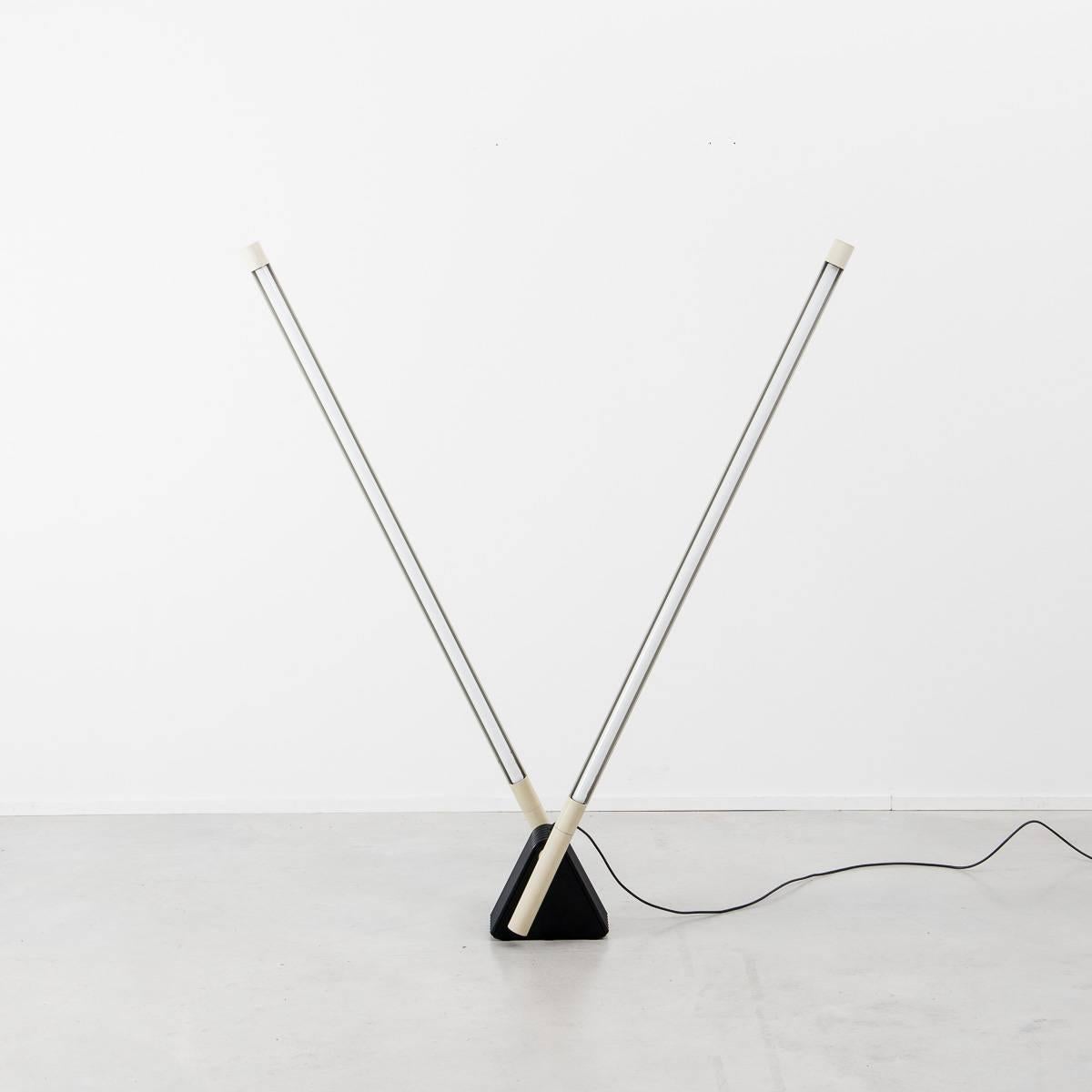 A sculptural piece of postmodern design which crosses the boundary where art meets lighting. The casing of the two fluorescent tubes can be rotated allowing either direct or indirect light or a combination of the two. The weighted base allows the