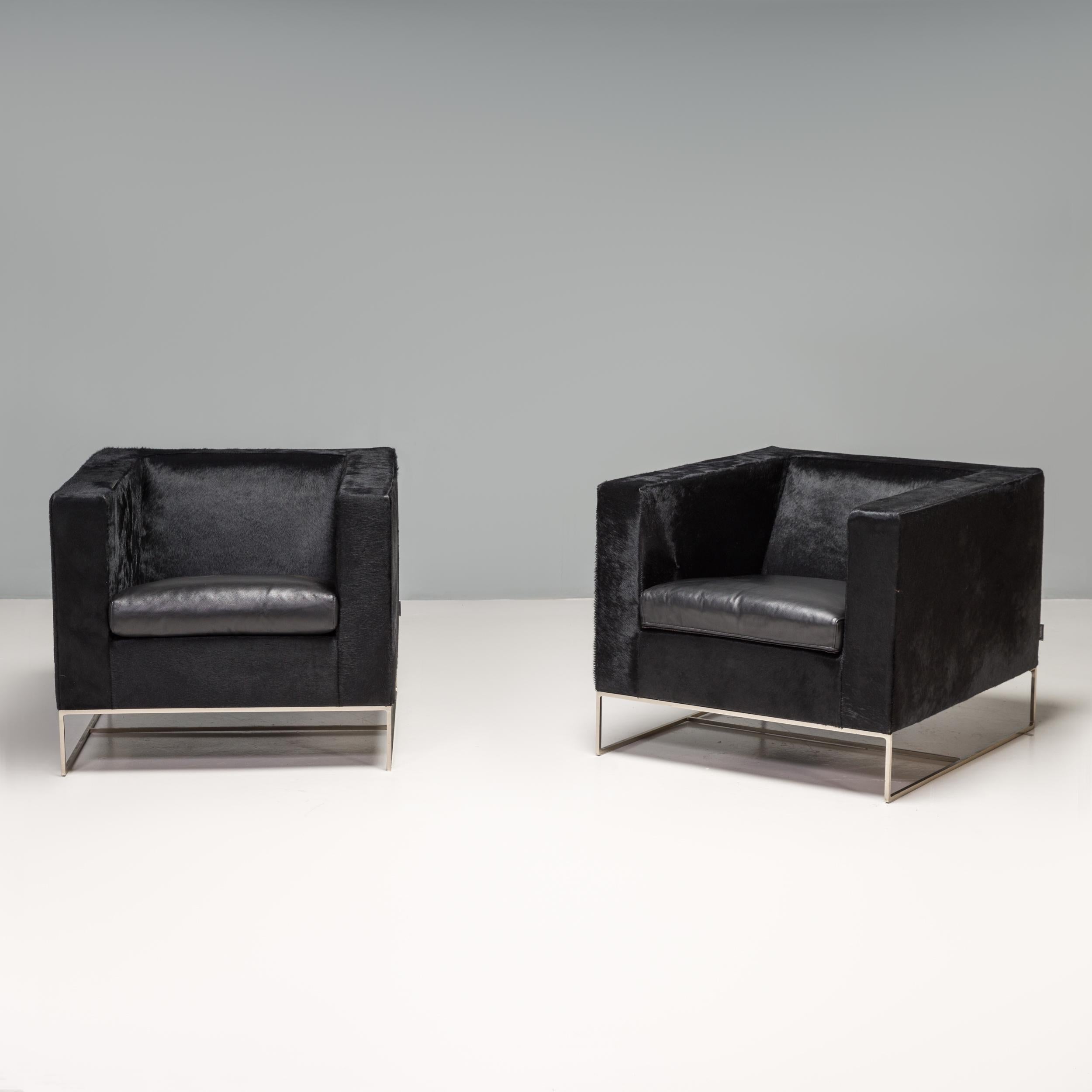 Designed by Rodolfo Dordoni for Minotti, the Klee armchair is a fantastic example of elegant modern Italian design.

The chairs have a bold cube silhouette, contrasted by a sleek, angular base constructed from hand-worked metal in a polished