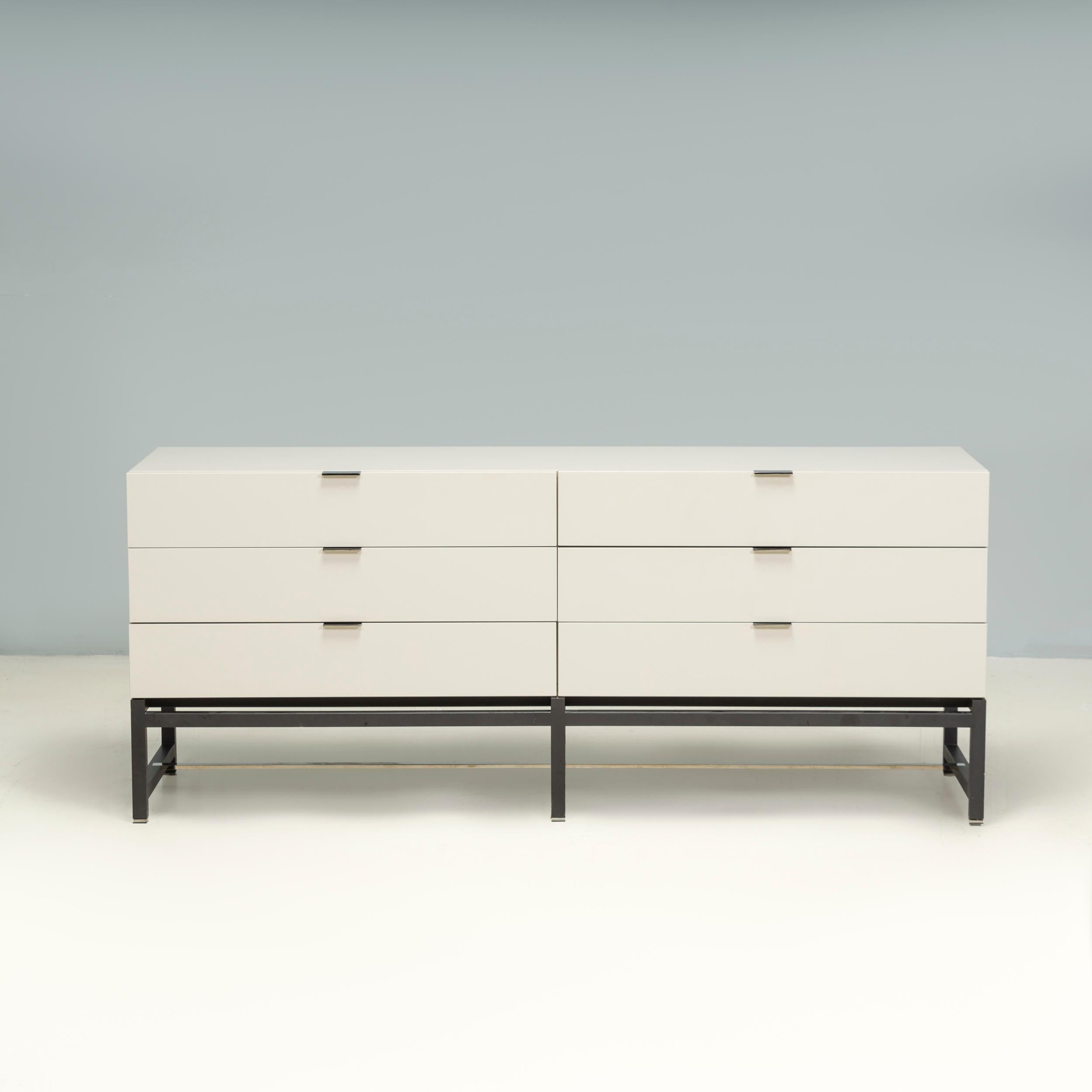 Designed by Rodolfo Dordoni for Minotti, the Harvey chest of drawers is a fantastic example of contemporary design.

Constructed from wood with a white gloss lacquer finish, the chest of drawers sits on an angular base in a contrasting Moka