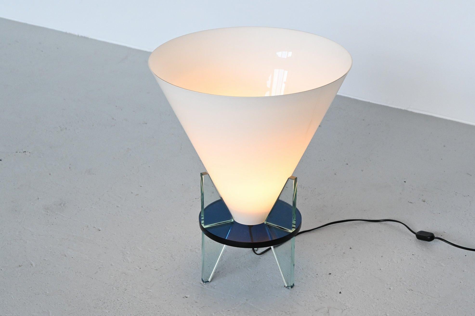 Imposing unusual table lamp model 2748 Otero designed by Rodolfo Dordoni for Fontana Arte, Italy, 1986. This lamp has a stunning shape because of the conical light diffuser. The white opaline glass inverted cone scale is resting on a round tripod