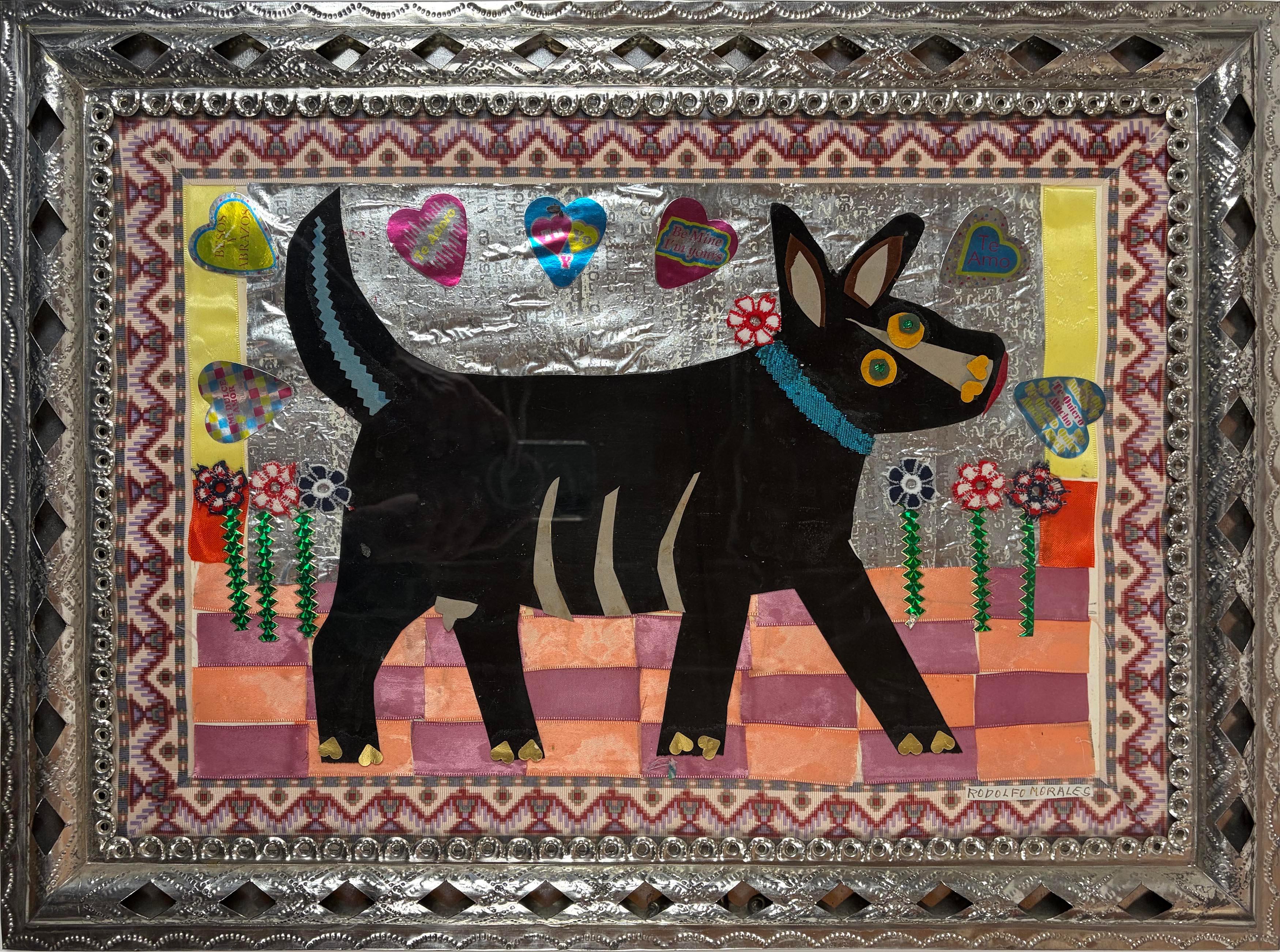 A charming and characteristic mixed-media collage by Mexican master Rodolfo Morales (1925–2001), featuring a stylized black dog set against a shimmering silver ground and surrounded by hearts, flowers, and textile elements. Morales is celebrated for
