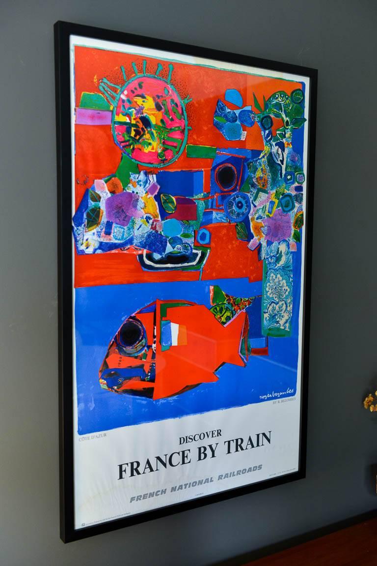 Vintage original travel poster from 1968 by Roger Bezombes titled Côte d'Azur (French Riviera) Discover France by Train, 1968. Sourced from original owners of travel agency in San Clemente, CA. Not a reproduction. Professionally mounted and framed