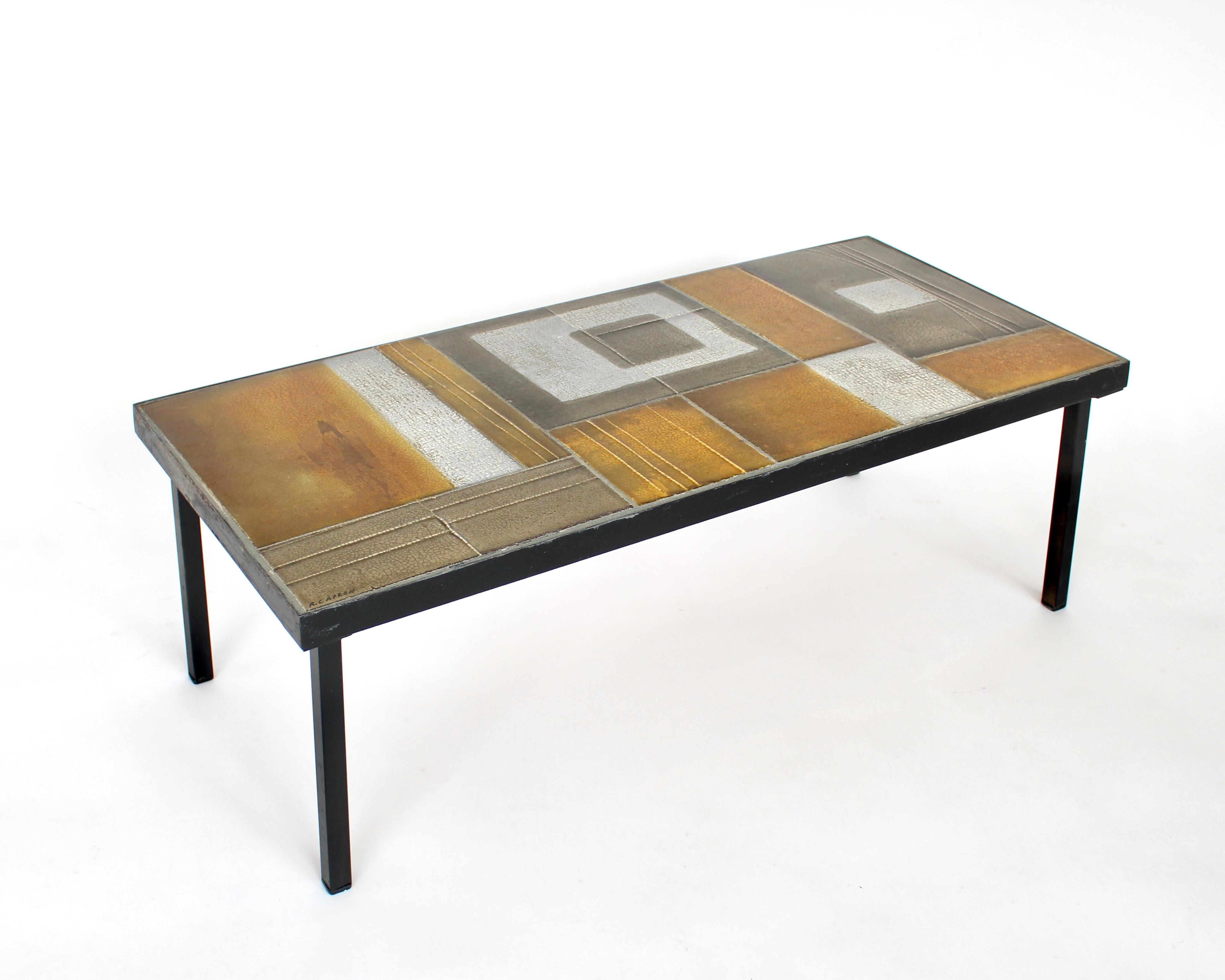 Roger Capron ceramic tiled coffee table in an abstract design and arrangement of the tiles. 
This style was often done by Capron during the 60's which was less literal and more abstract. The use of color is very different than the previous more