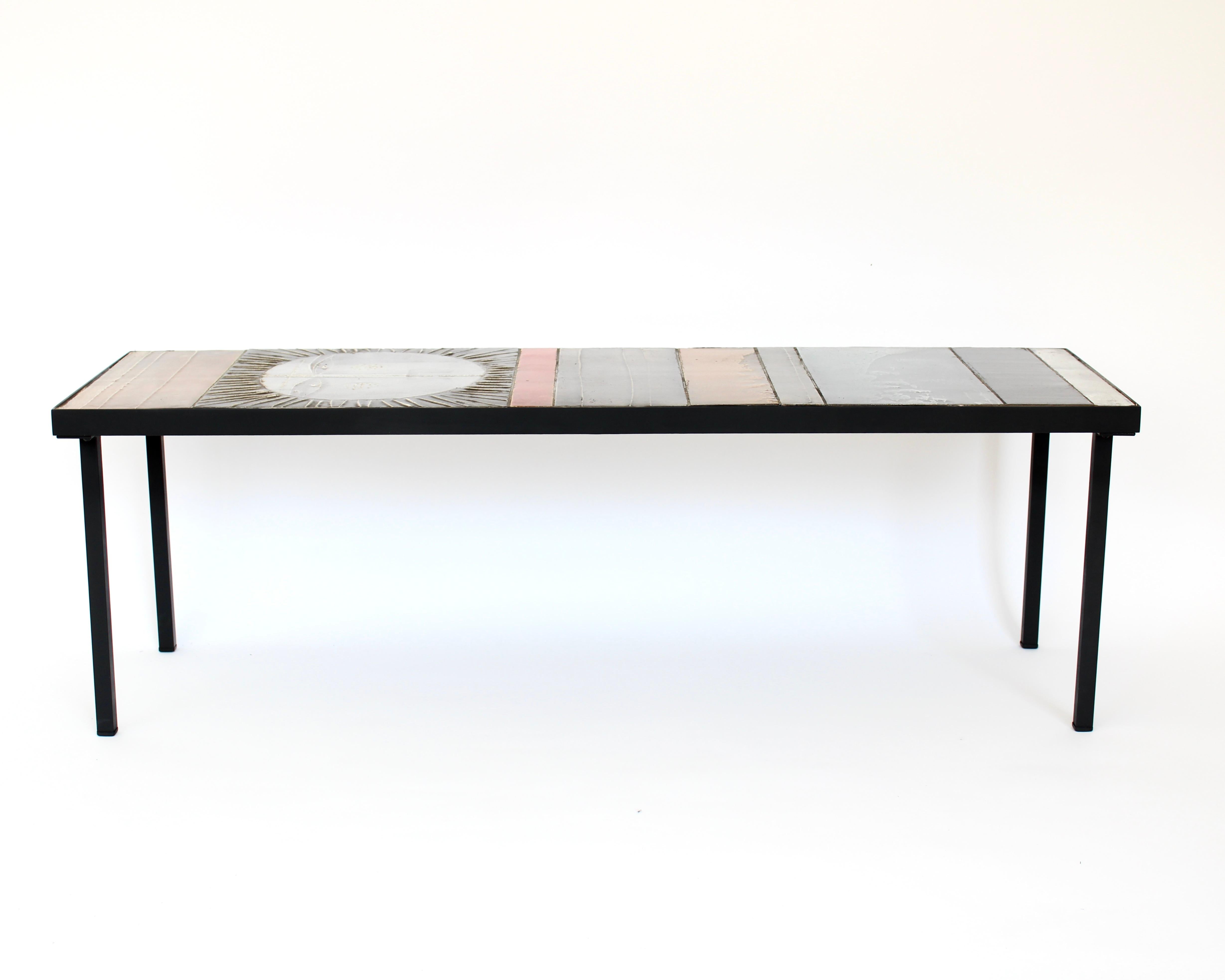 Exceptional table composed colorful abstract ceramics on a steel structure covered in, one of which is a large radiant sun. This is the large edition and an iconic piece by Roger Capron, one of the greatest post war French Ceramicists.
This image of