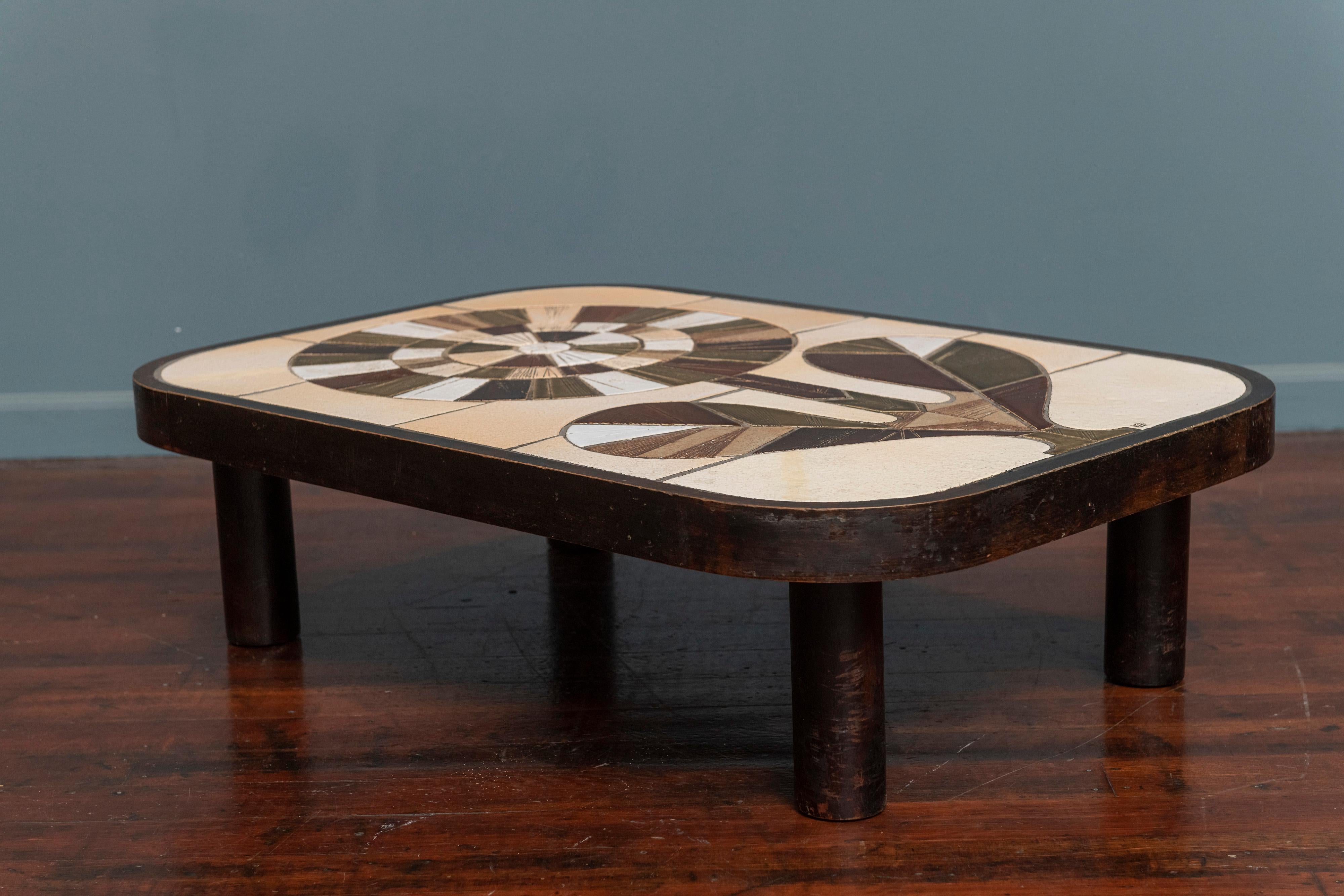 Roger Capron ceramic low coffee table, France. Bohemian chic studio craft tile top coffee table by Roger Capron, signed. In very good vintage condition with signs of wear to the stained bentwood frame and four cylindrical legs.