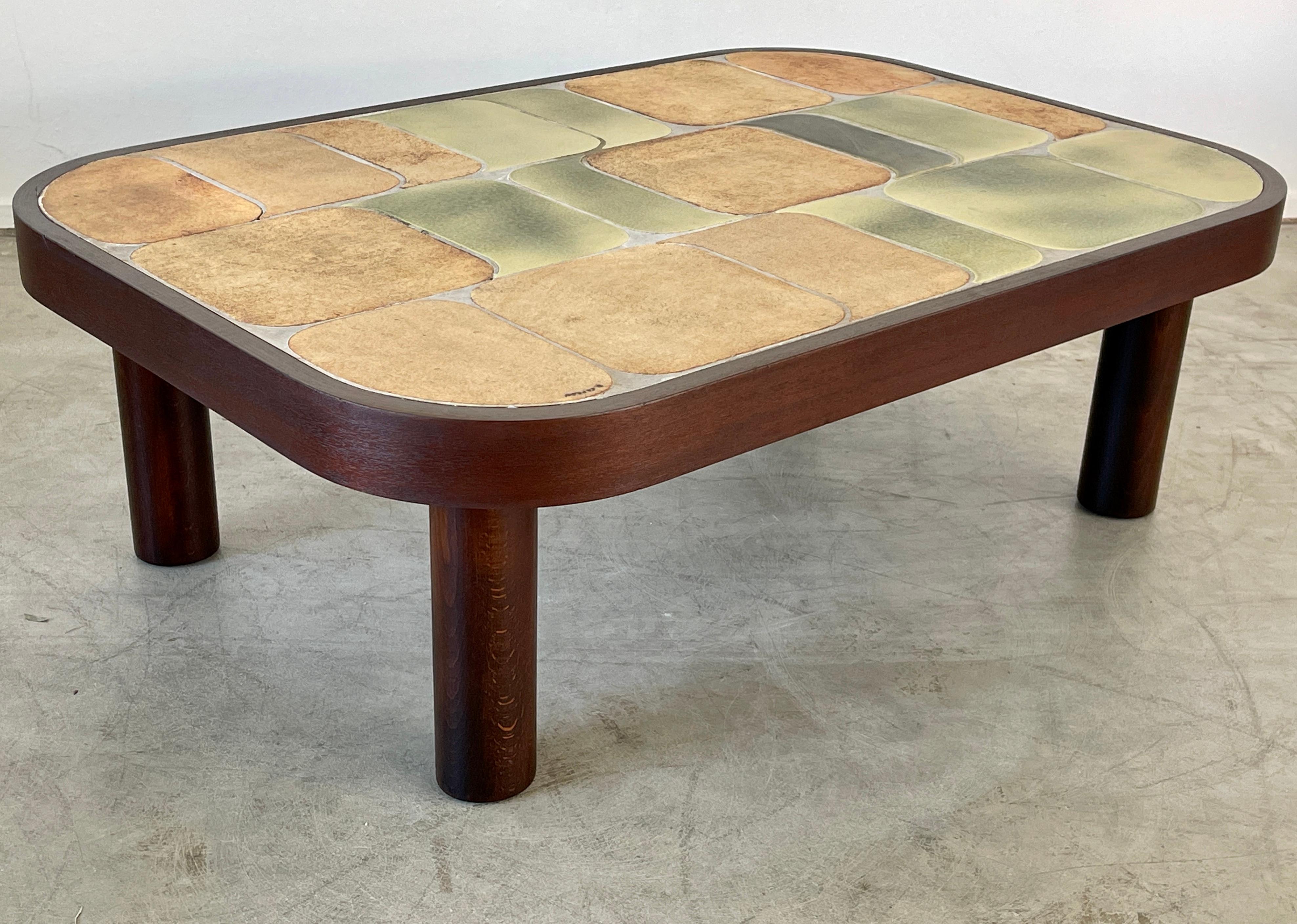 Wonderful ceramic tile top coffee table designed by Roger Capron. (signed) 
Features his unique 