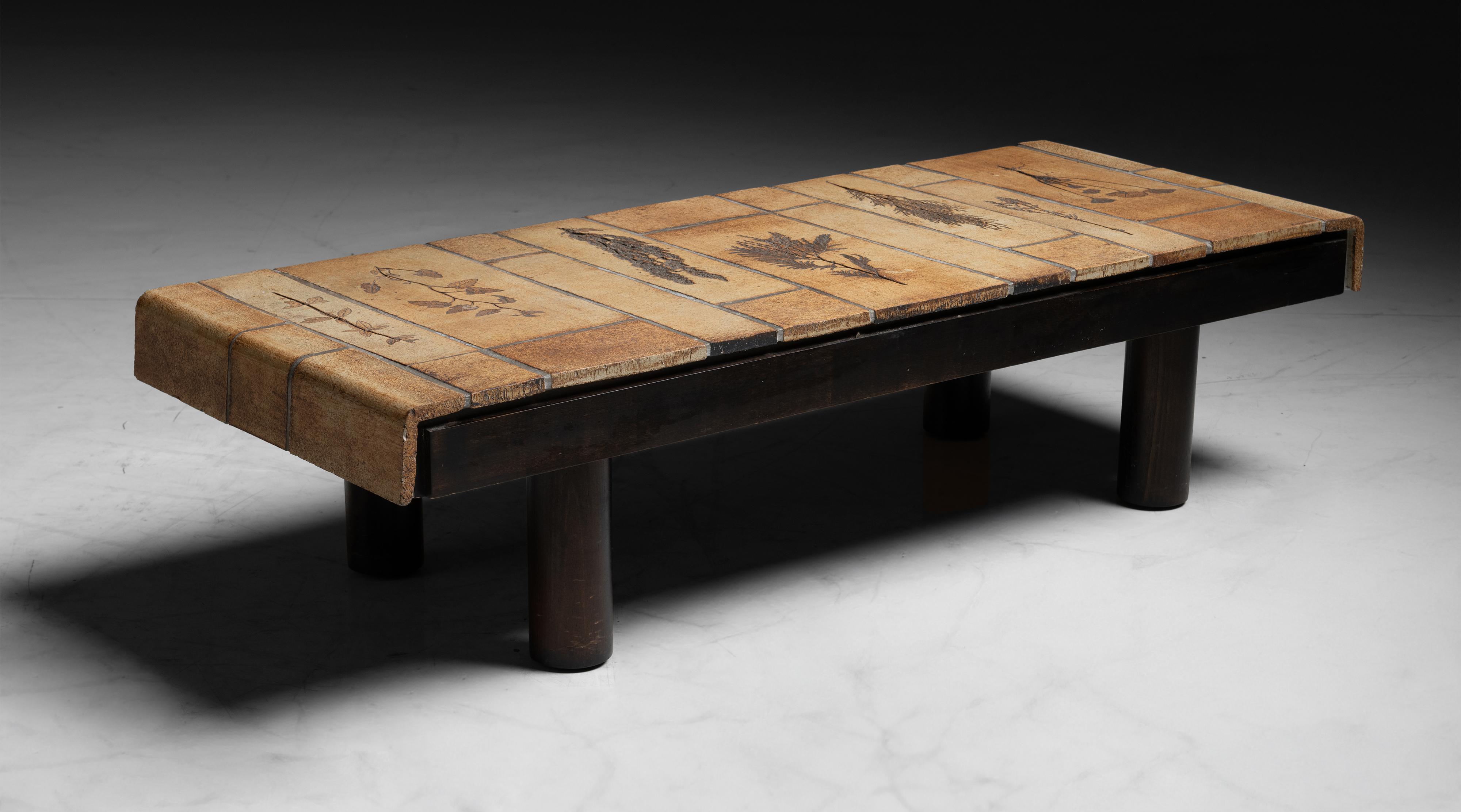 Roger Capron Coffee Table
France circa 1975
Wooden frame and tiled tabletop, with stamped leaf motifs.
46”L x 18”d x 11.5”h