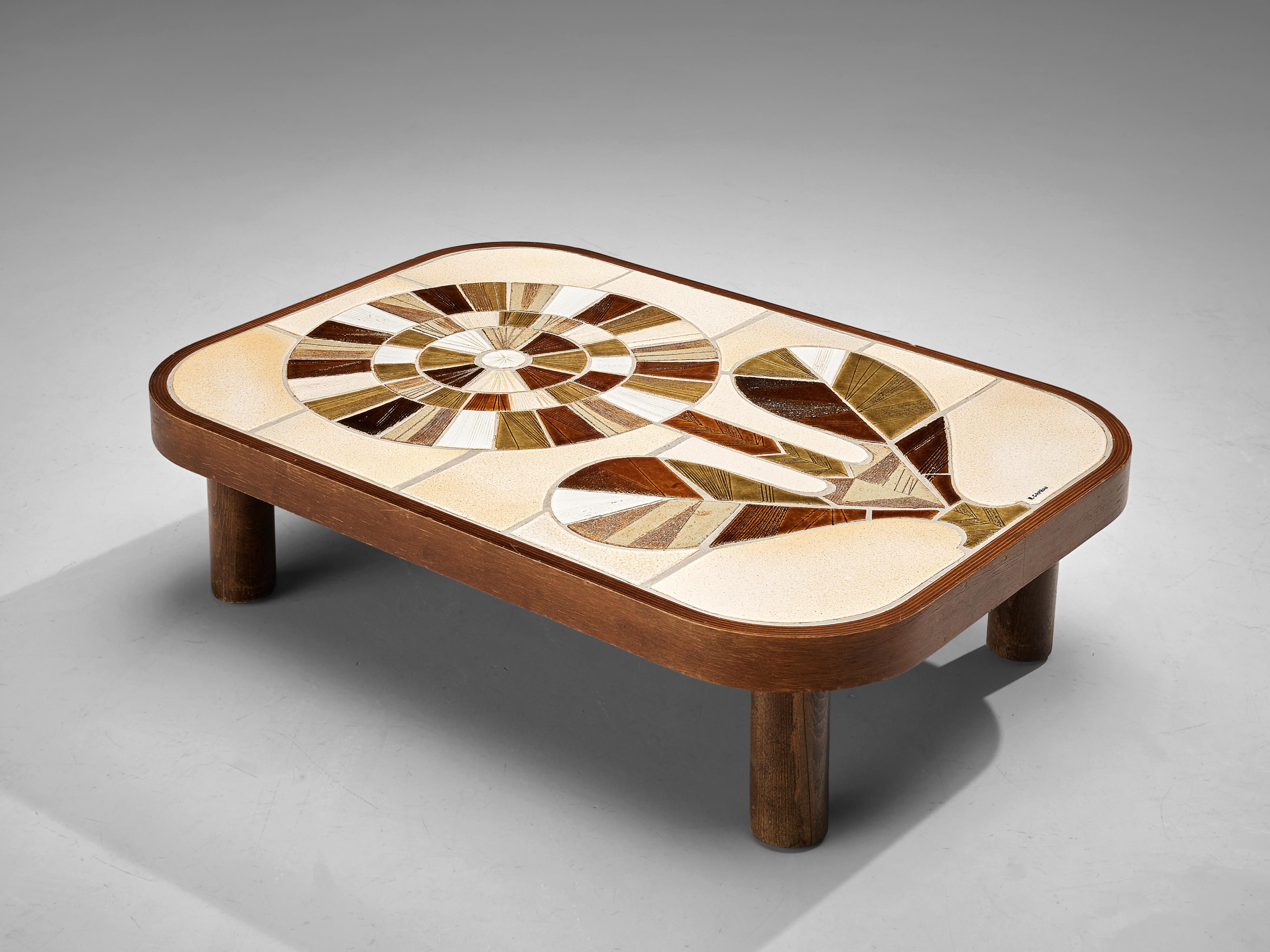 Roger Capron, coffee table, ceramic, wood, France, 1960s 

French coffee table with wonderful composed ceramic tiles by French ceramic artist Roger Capron. It features a vibrant motif of a flower created by differently colored fragments. A