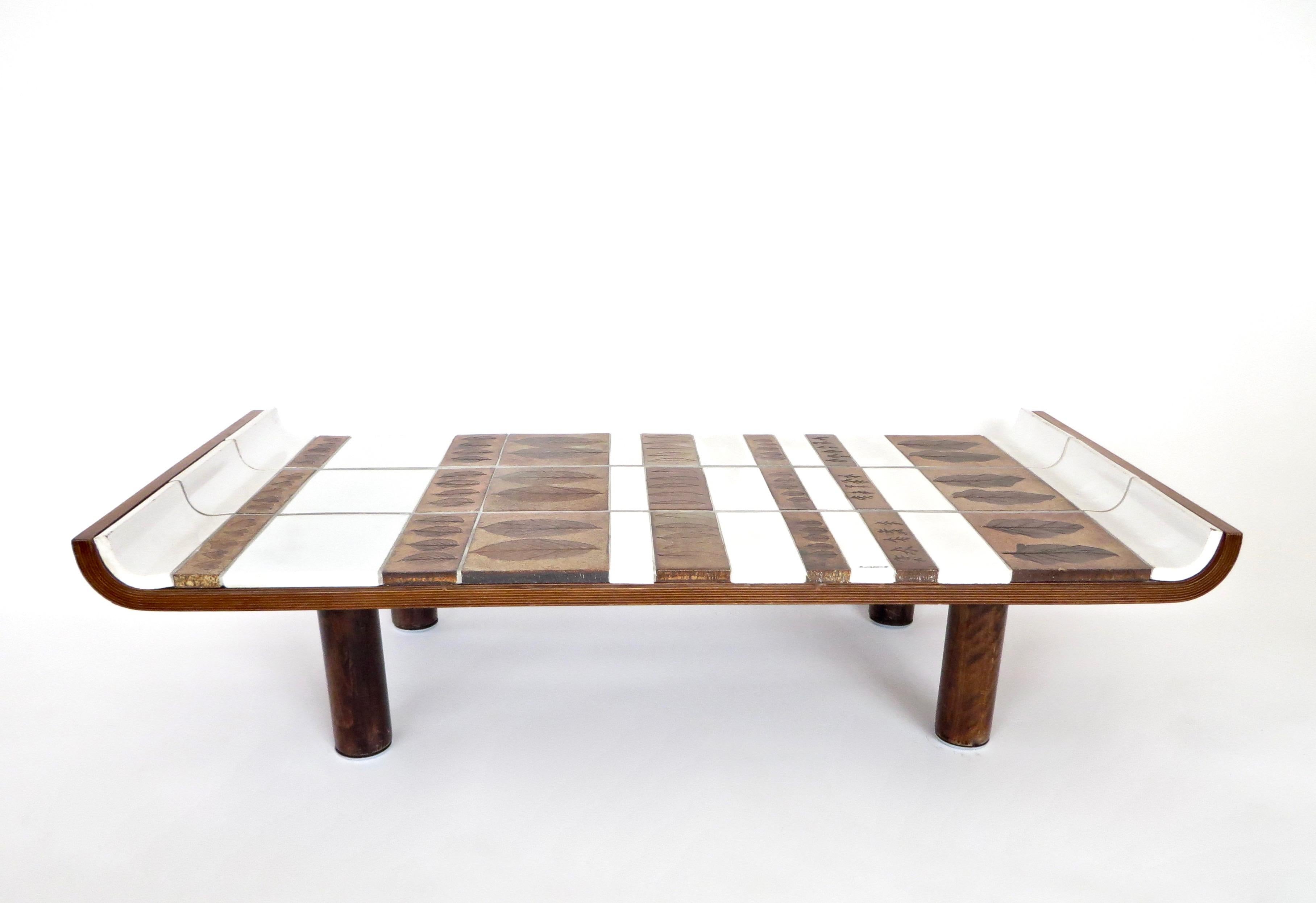 Roger Capron Pagode model ceramic coffee table, circa 1960.
Oak frame supporting white glazed tiles and tones of brown ceramic tiles with impressed leaves in the ceramic in the iconic impressed leaf series of Roger Capron in the 1960s.
Capron worked