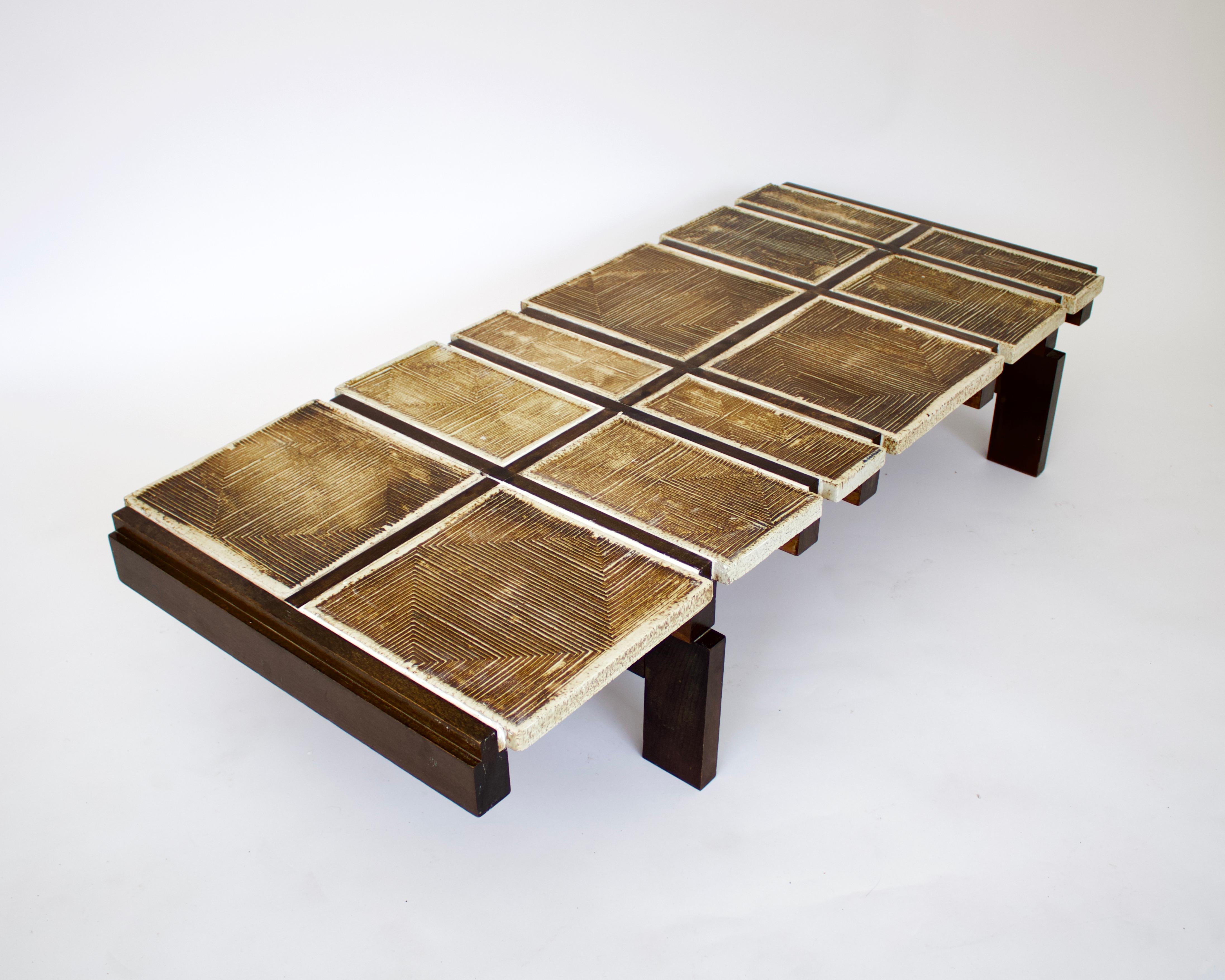 A ceramic tile coffee table by Roger Capron, model Alouette, 1970-1971.
This rare coffee table from one of the masters of ceramics and ceramic tile coffee tables from Vallauris is composed of heavily scraffito tiles on a dark wood base.
It is