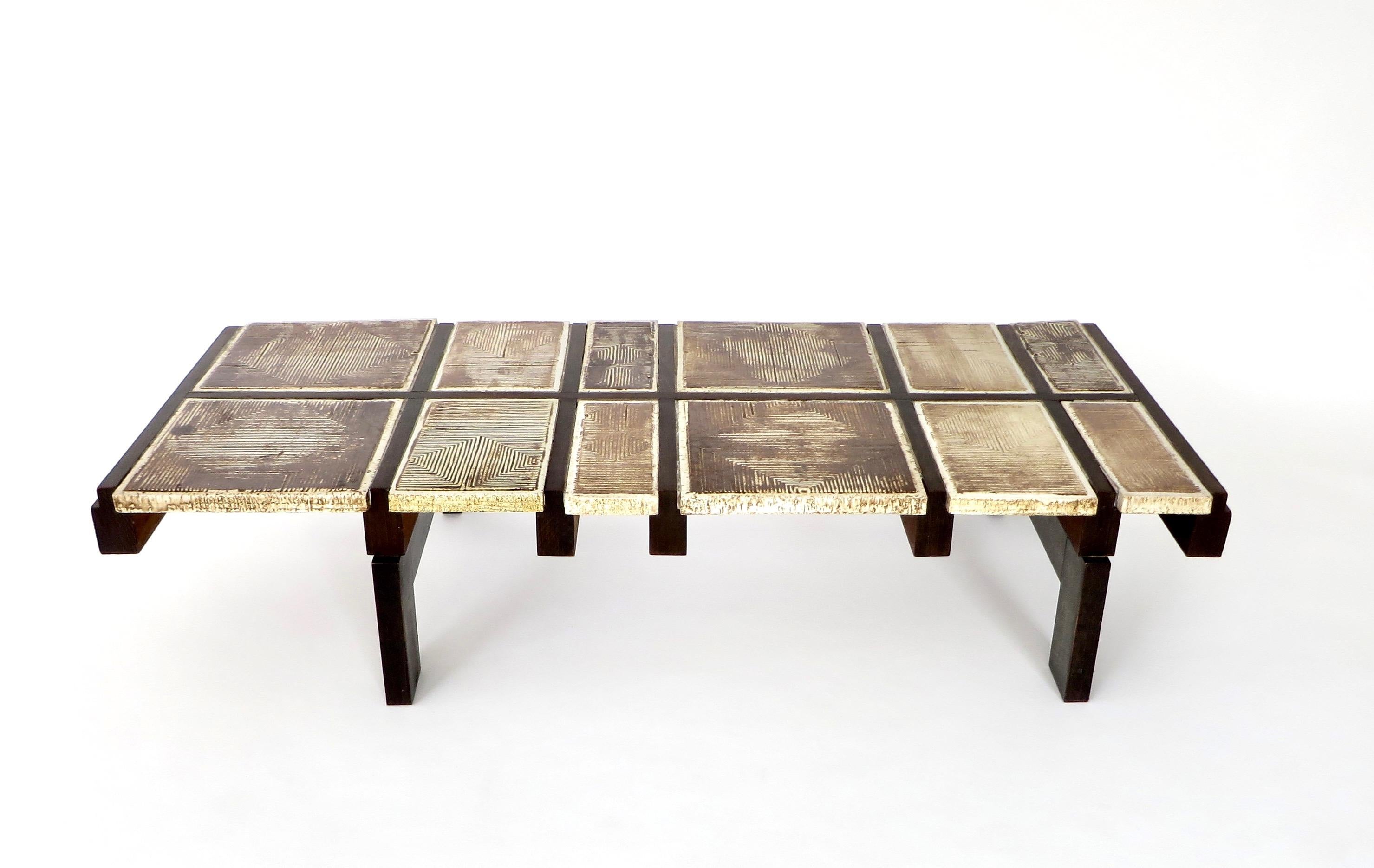 A ceramic tile coffee table by Roger Capron, model Alouette, 1970-1971.
This rare coffee table from one of the masters of ceramics and ceramic tile coffee tables from Vallauris is composed of heavily scraffito tiles on a dark wood base.
It is