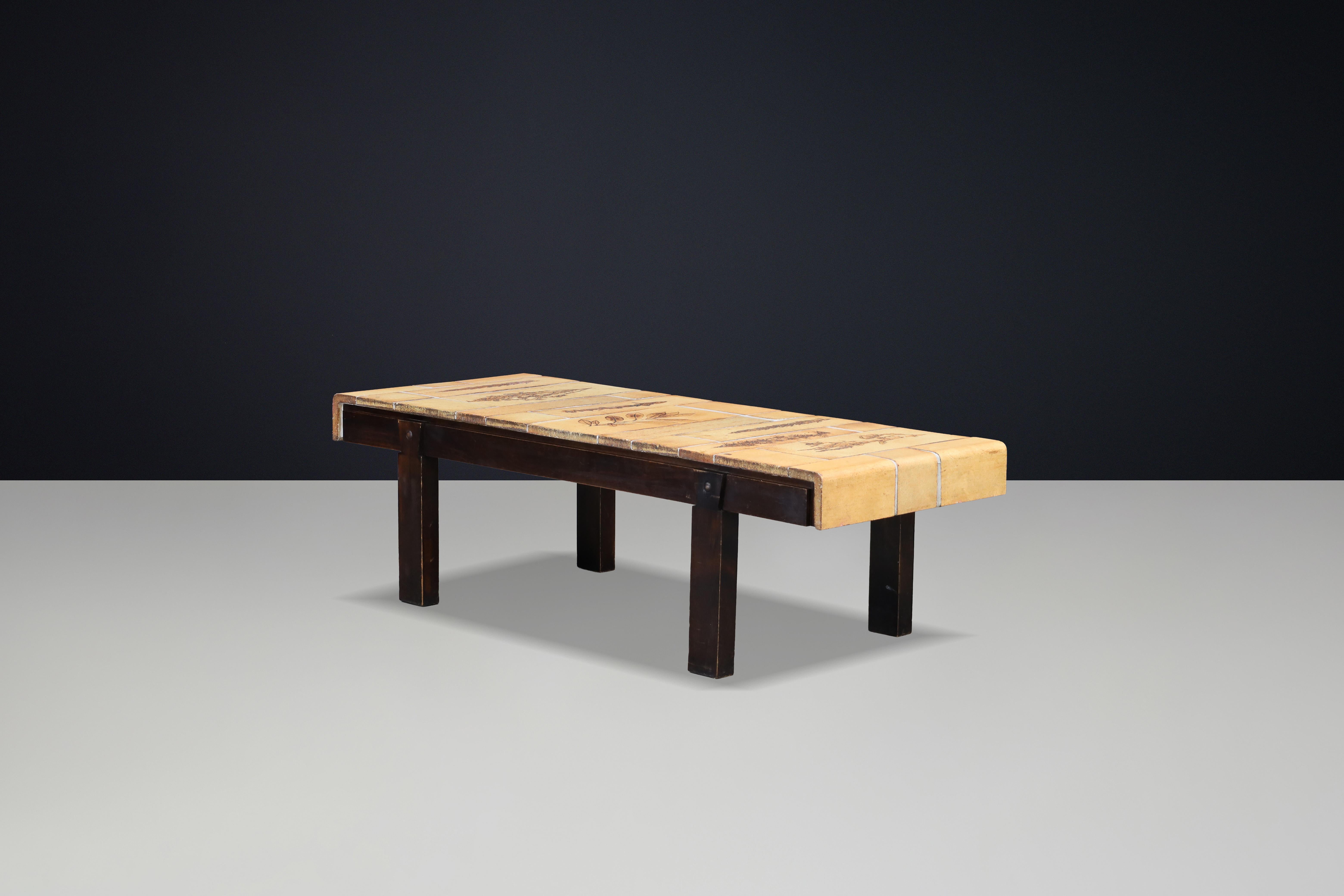 Handcrafted Roger Capron coffee table featuring iconic Garrigue tiles with pressed botanical leaf imprints, produced in Vallauris, France.

This large and decorative coffee table features the iconic Garrigue tiles by celebrated French ceramicist