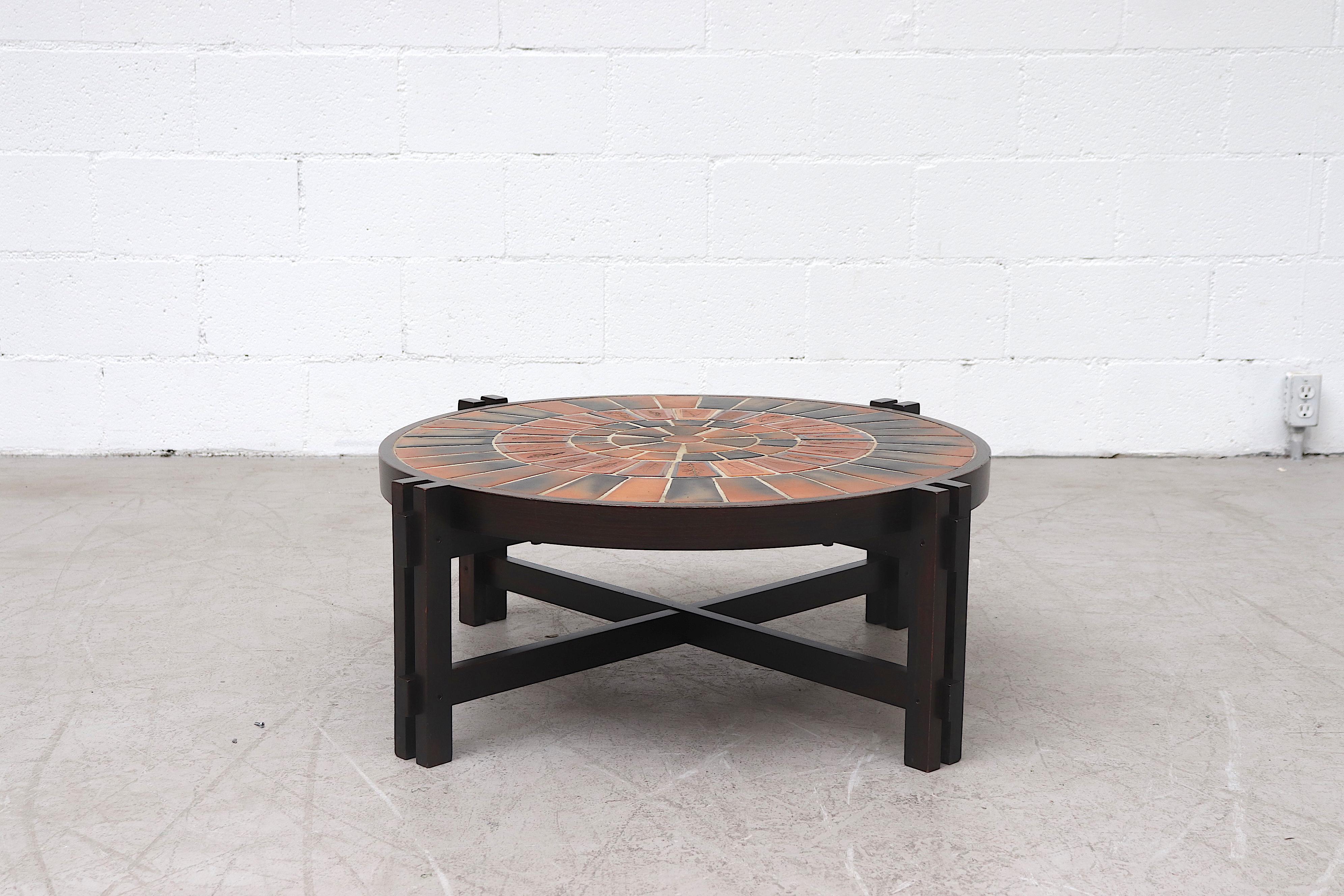 Roger Capron 'Garrigue' low round wood framed tile relief coffee table with exquisite pressed leaf tile work from Vallauris, France. Lightly refinished in impressive condition with light wear and some scratches to ceramic.