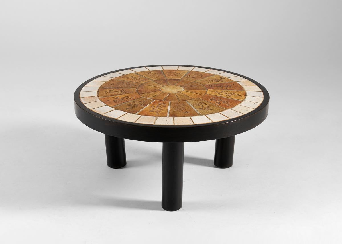 Roger Capron, the celebrated French mid-century ceramist, created a large body of work notable for its elegance, varied sources of inspiration, and expert execution. This beautifully proportioned table boasts a round top of tiles into which delicate