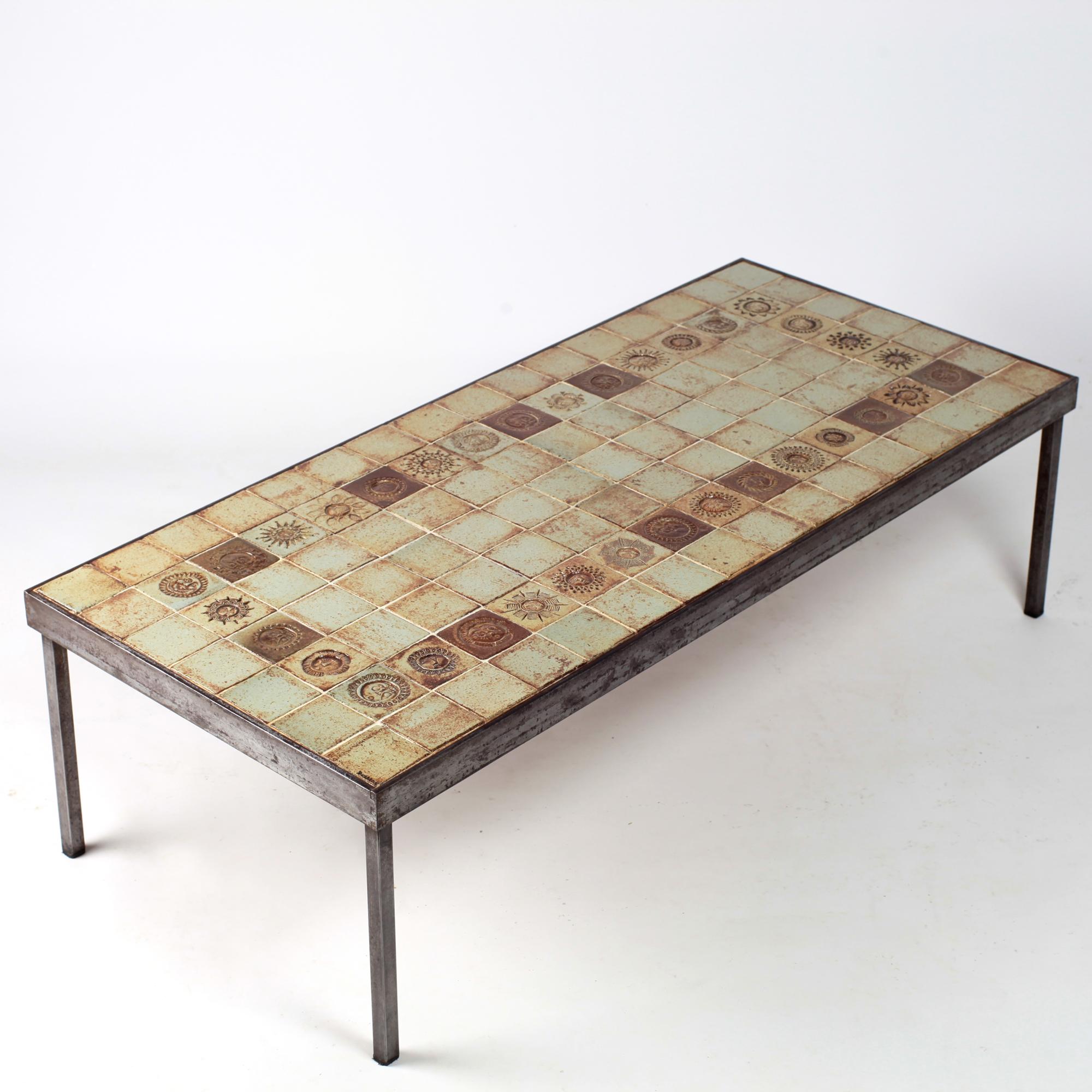 Beautiful dimensions for this rare Roger Capron coffee table created by his workshops in Vallauris in the 1960s. Composed of ceramic tiles in beige, caramel colors with a frame of tiles decorated with anthropomorphic suns all different, a beautiful